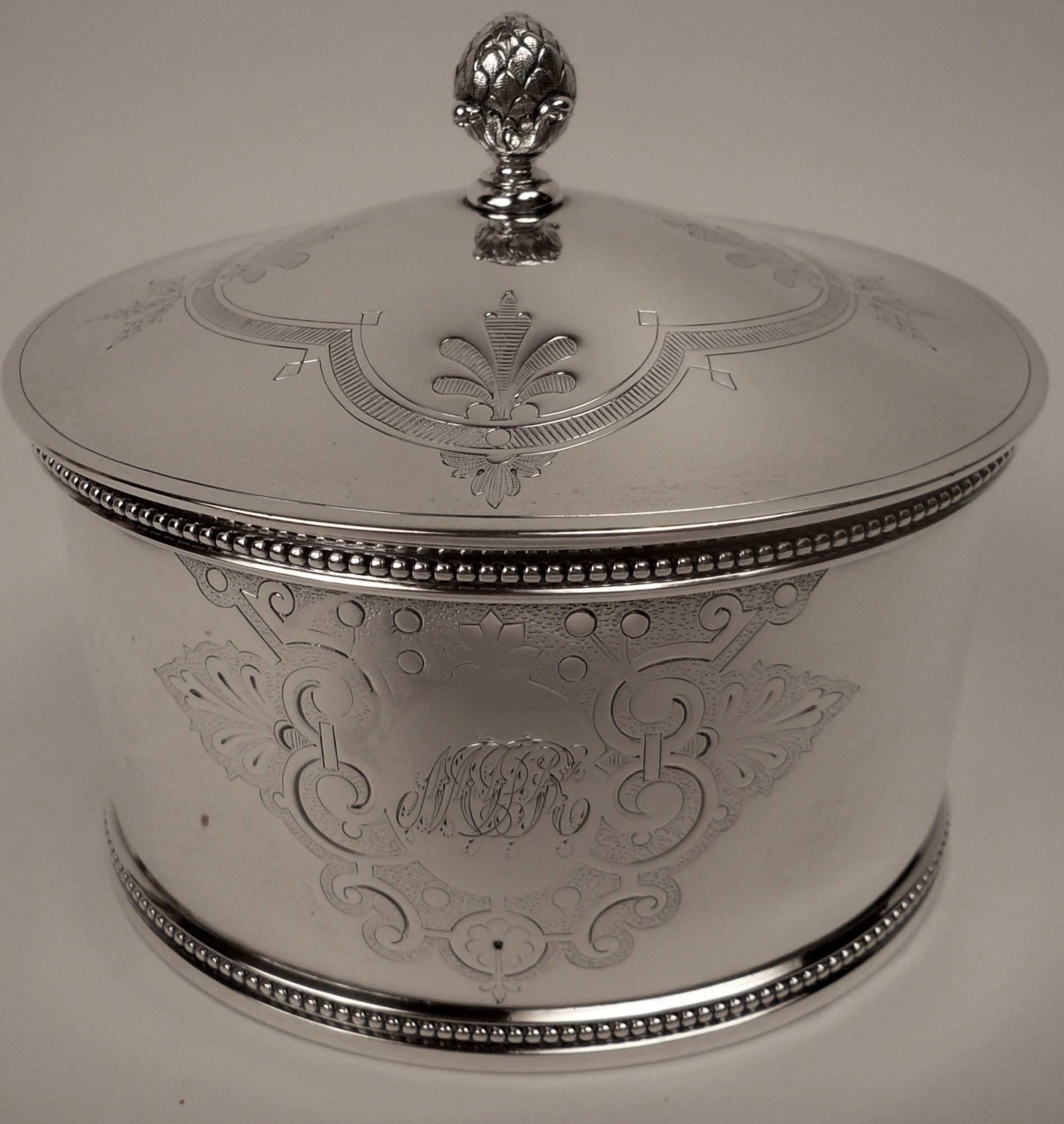 This hand chased heavy gauge sterling tea caddy was made in Boston by renowned makers Shreve and Stanwood, and weighs approximately 15 ounces.