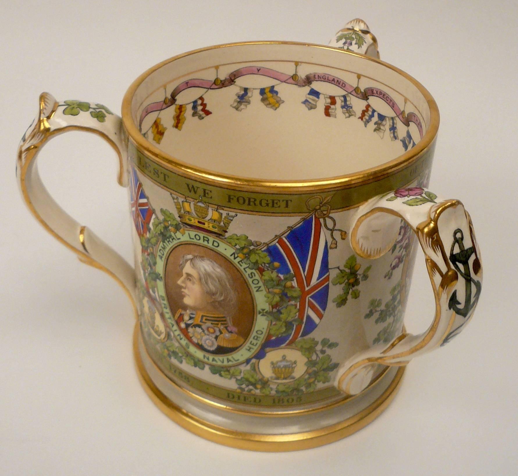An 'Edition De Luxe' Trafalgar centenary porcelain Tyg, 1905, subscribers copy #5. This rare English commemorative loving cup was retailed by T. Goode & Co.