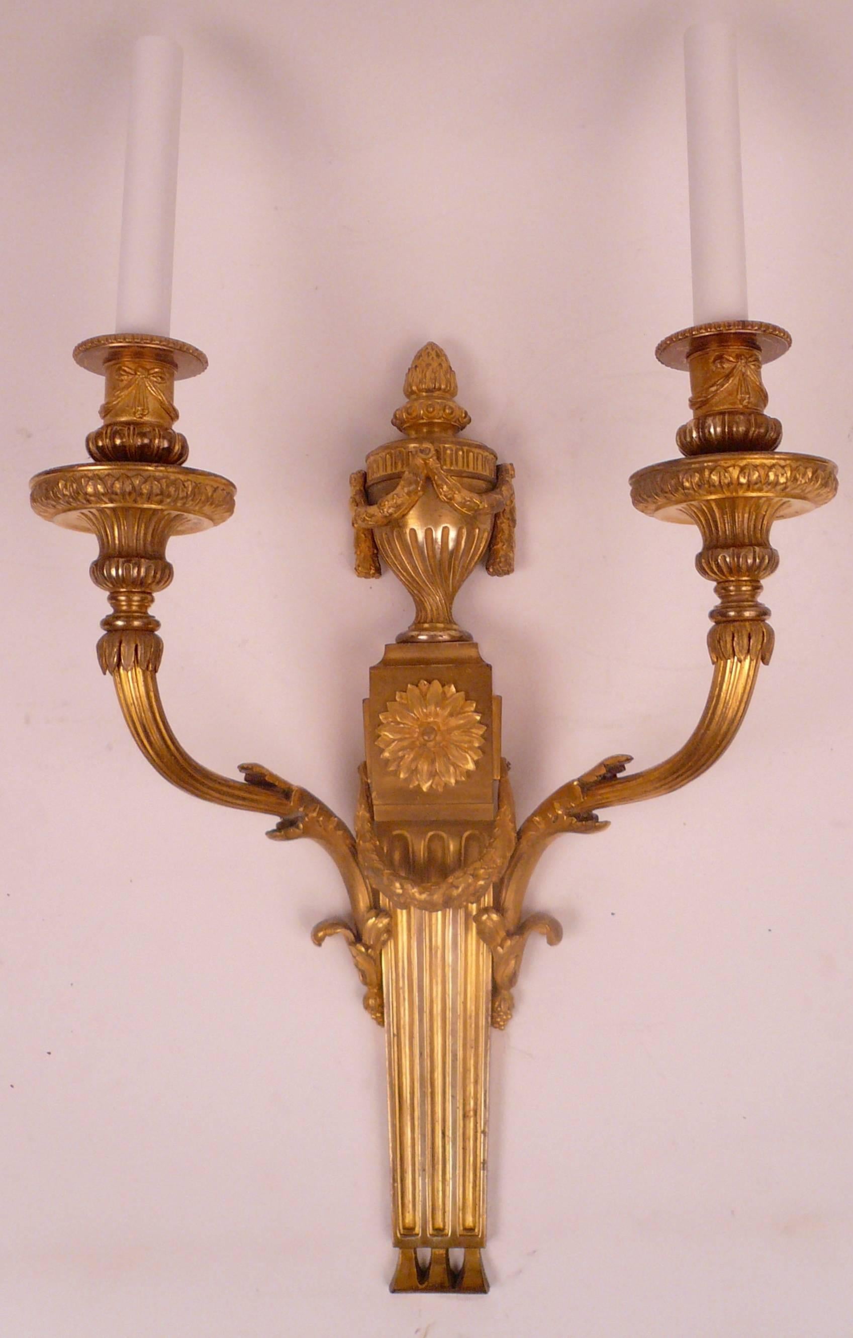 This handsome pair of caldwell two-light bronze sconces are finely detailed, and have their original finish.