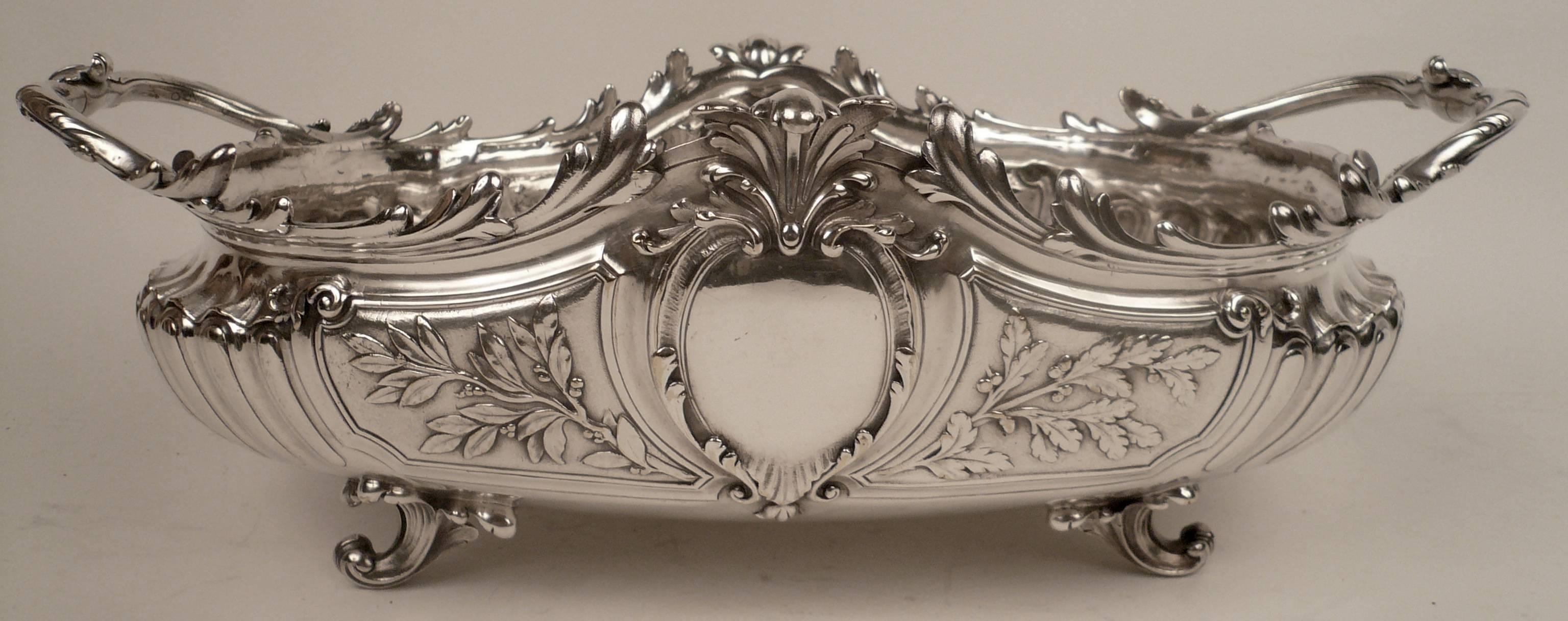 This grand silver plated bronze centerpiece bowl of sculptural form, has beautifully hand chased details.