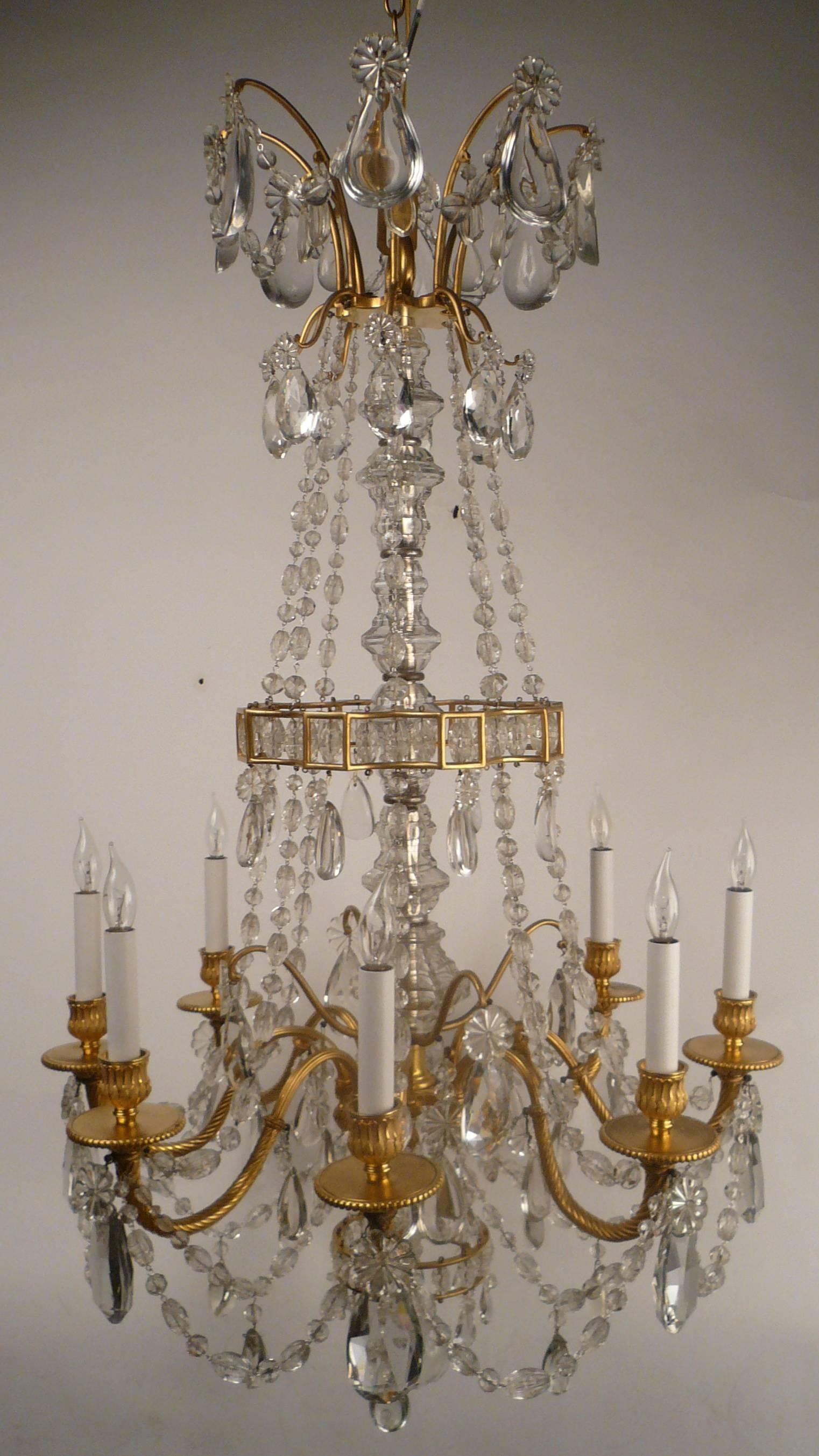 This Baccarat quality fixture is beautifully cast and hand chased in gilt bronze, and the prisms are of the finest quality. It was made in France, and retailed by Edward F. Caldwell.