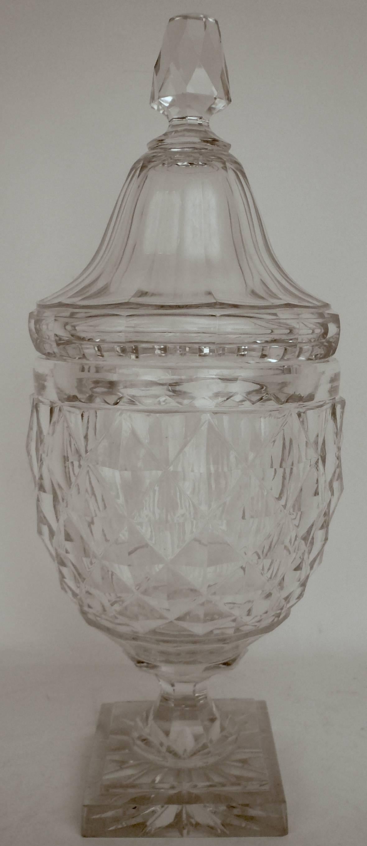 This handsome, diamond pattern, and panel cut crystal urn form lidded jar is in fine original condition.