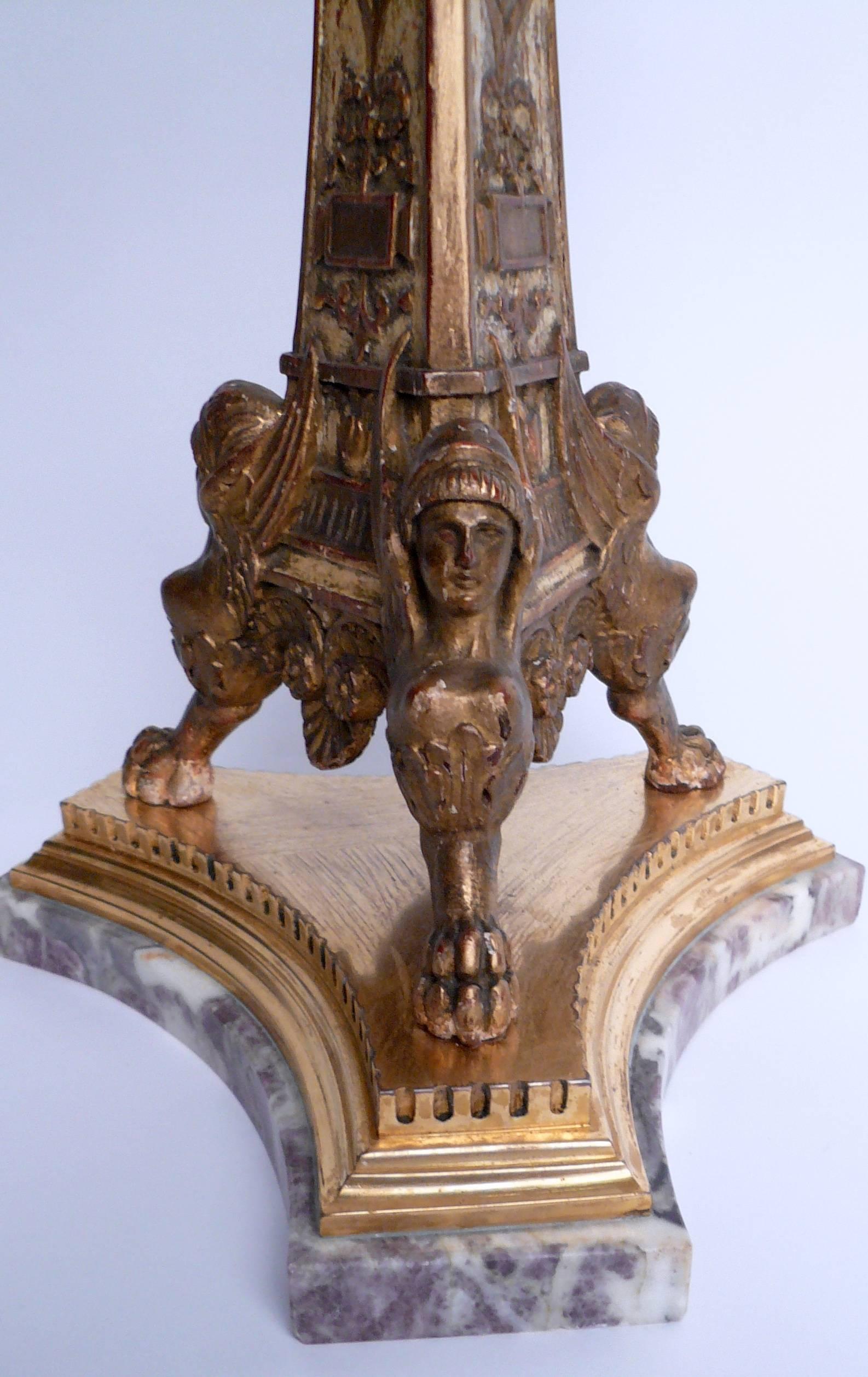 This Caldwell lamp features Classical motifs, including acanthus leaves and urns on a tripod sphinx form base.
