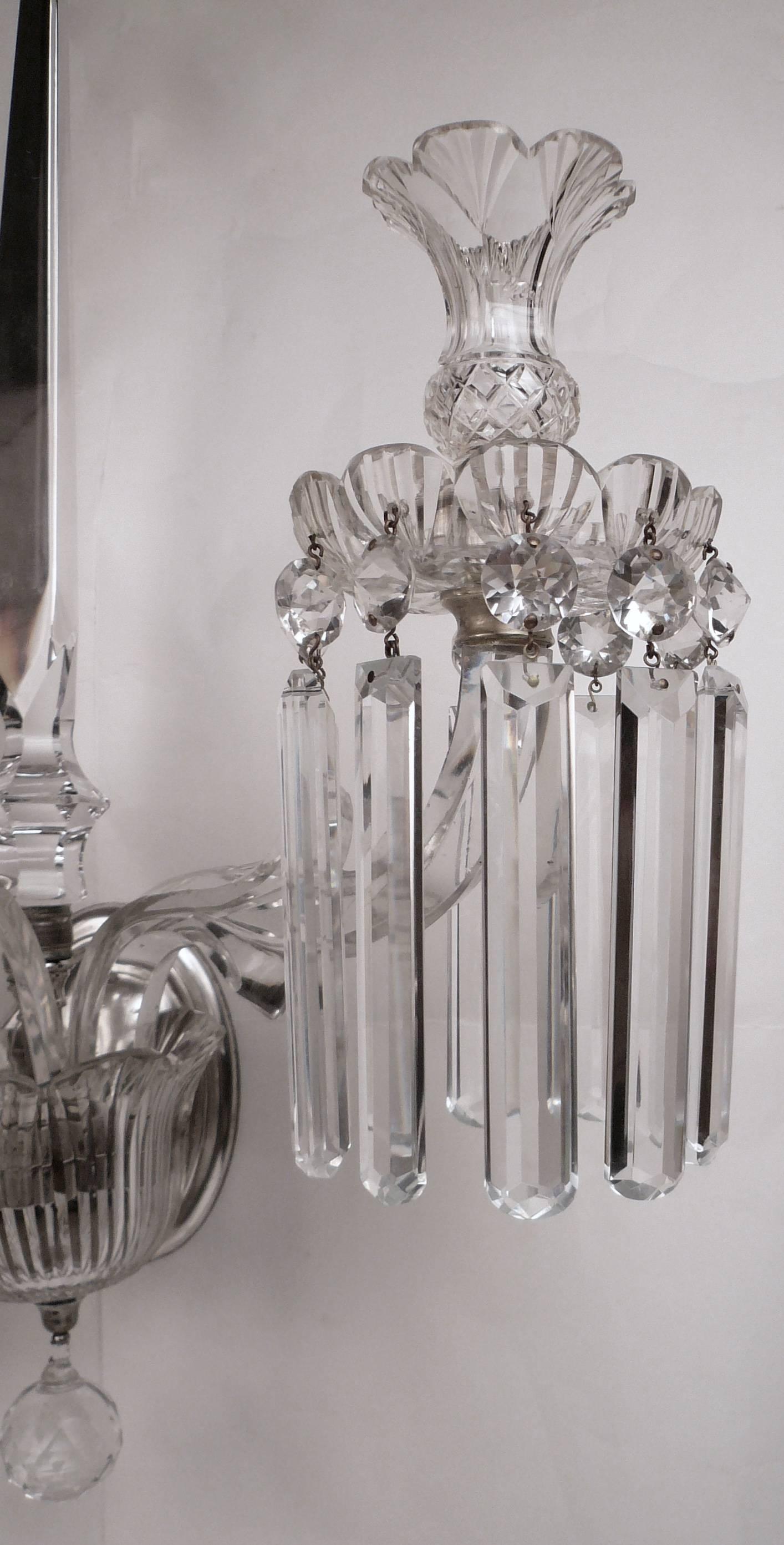 This huge candle powered three arm sconce features rule cut prisms with jewel cut rondels, and silver plated fittings.