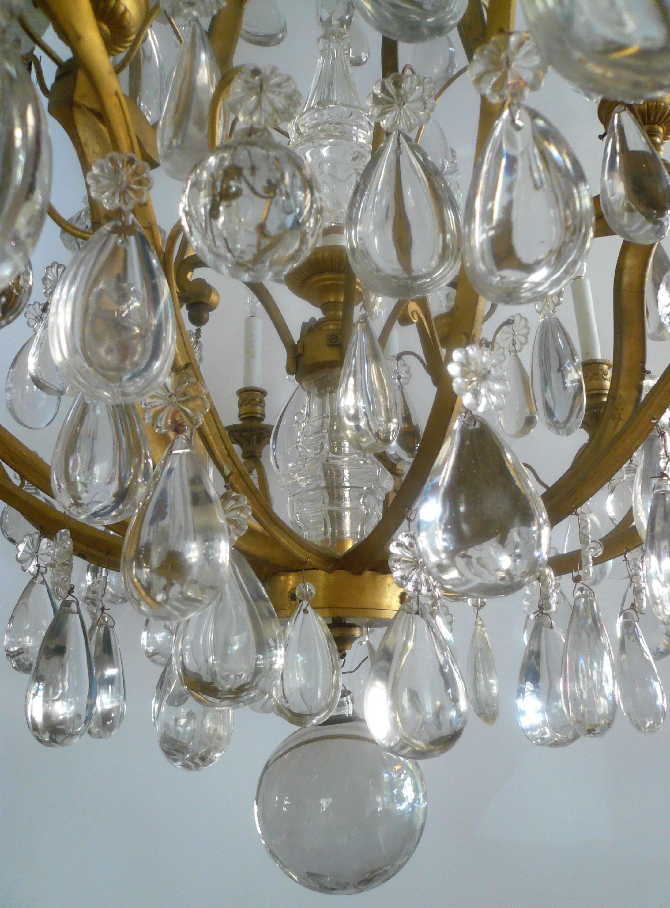 This extra fine quality chandelier attributed to Baccarat, has a matching pair of sconces, also available in my listings. With 12 arms and seventeen lights (the five larger hollow spikes contain light sockets), this is a superior fixture.