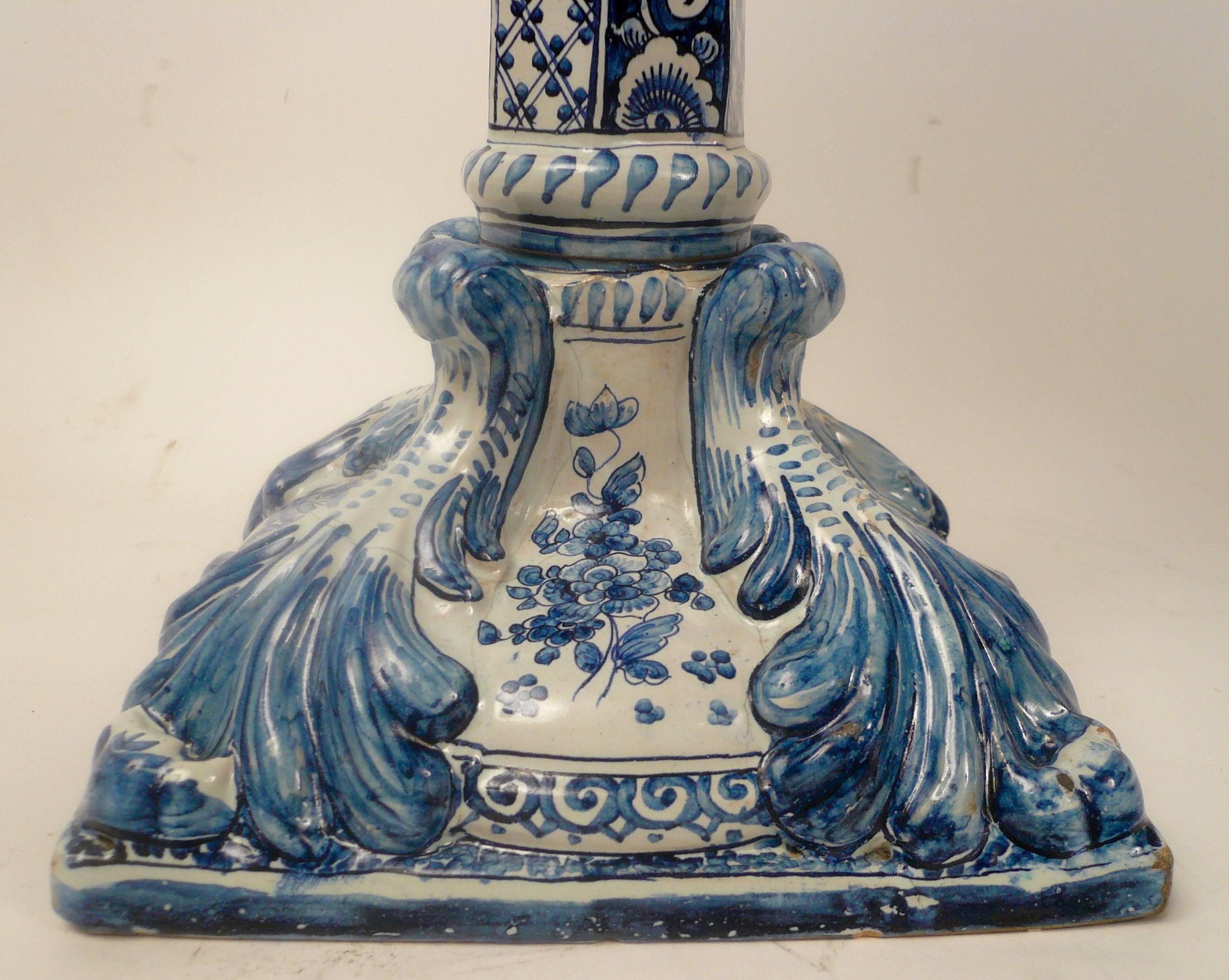 Blue and white hand-painted faience pottery columnar lamp, with scenic decorated font.