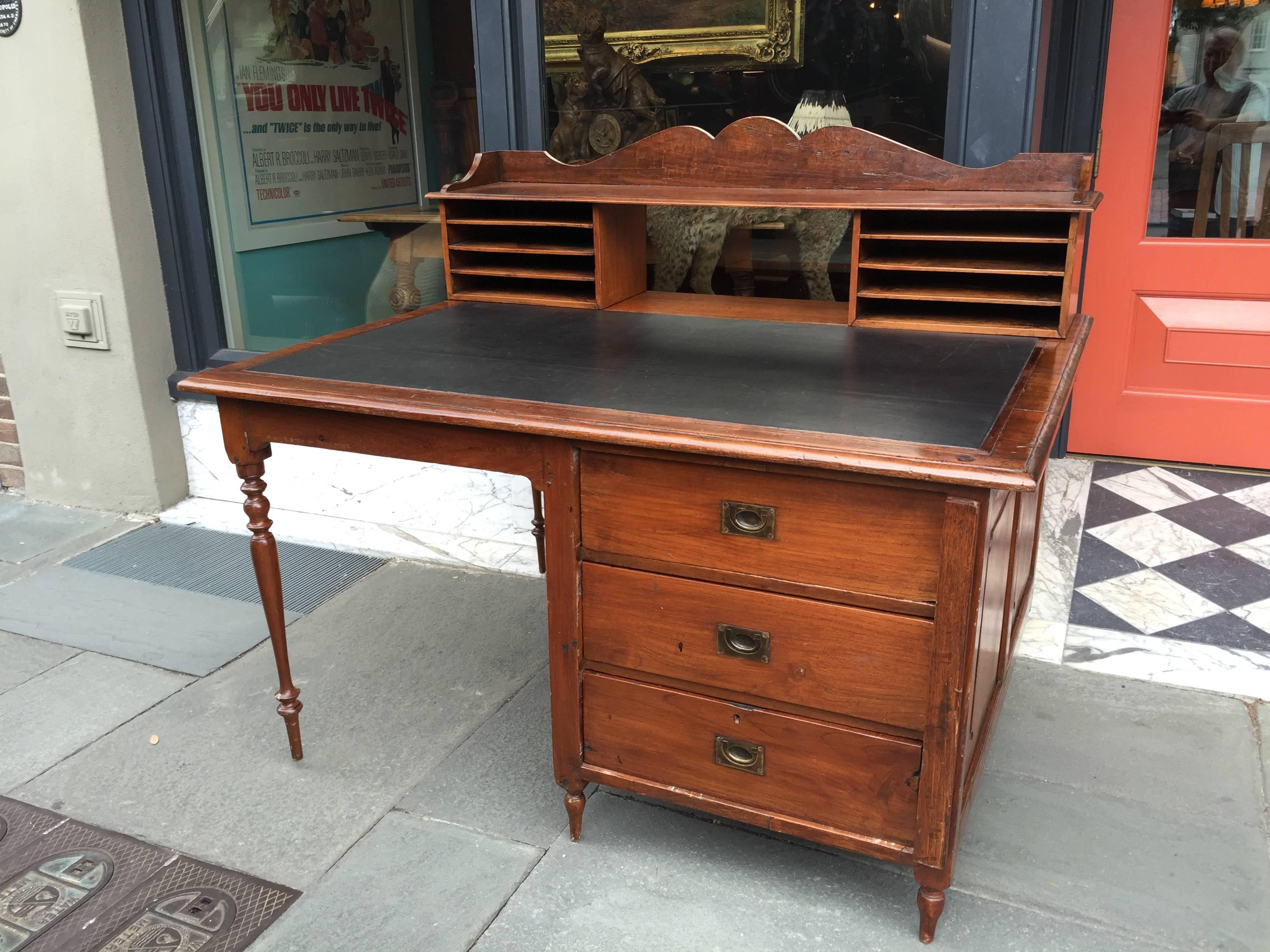 Teak large leather top writing desk with three drawers on base. Nice compartmentalized upper section for letters and other papers.