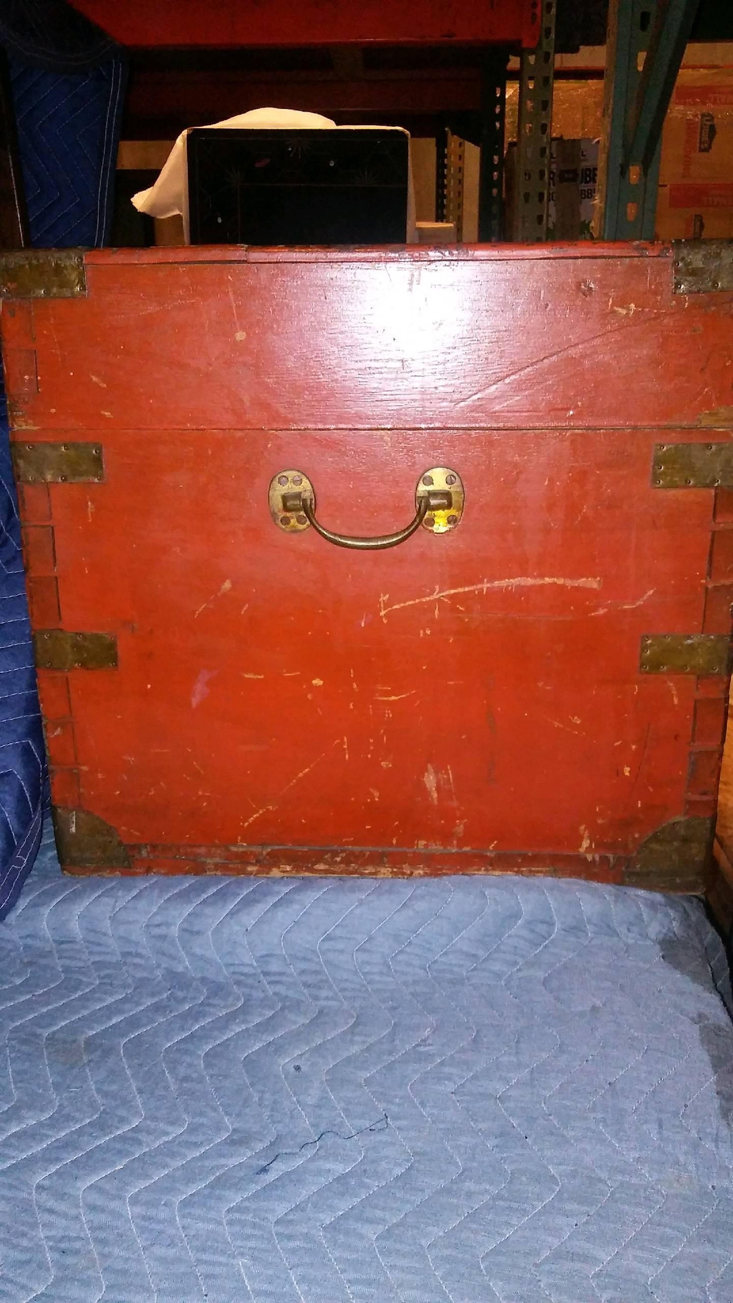 English camphor wood shipping trunk with brass mounts. Orange paint added at later date.