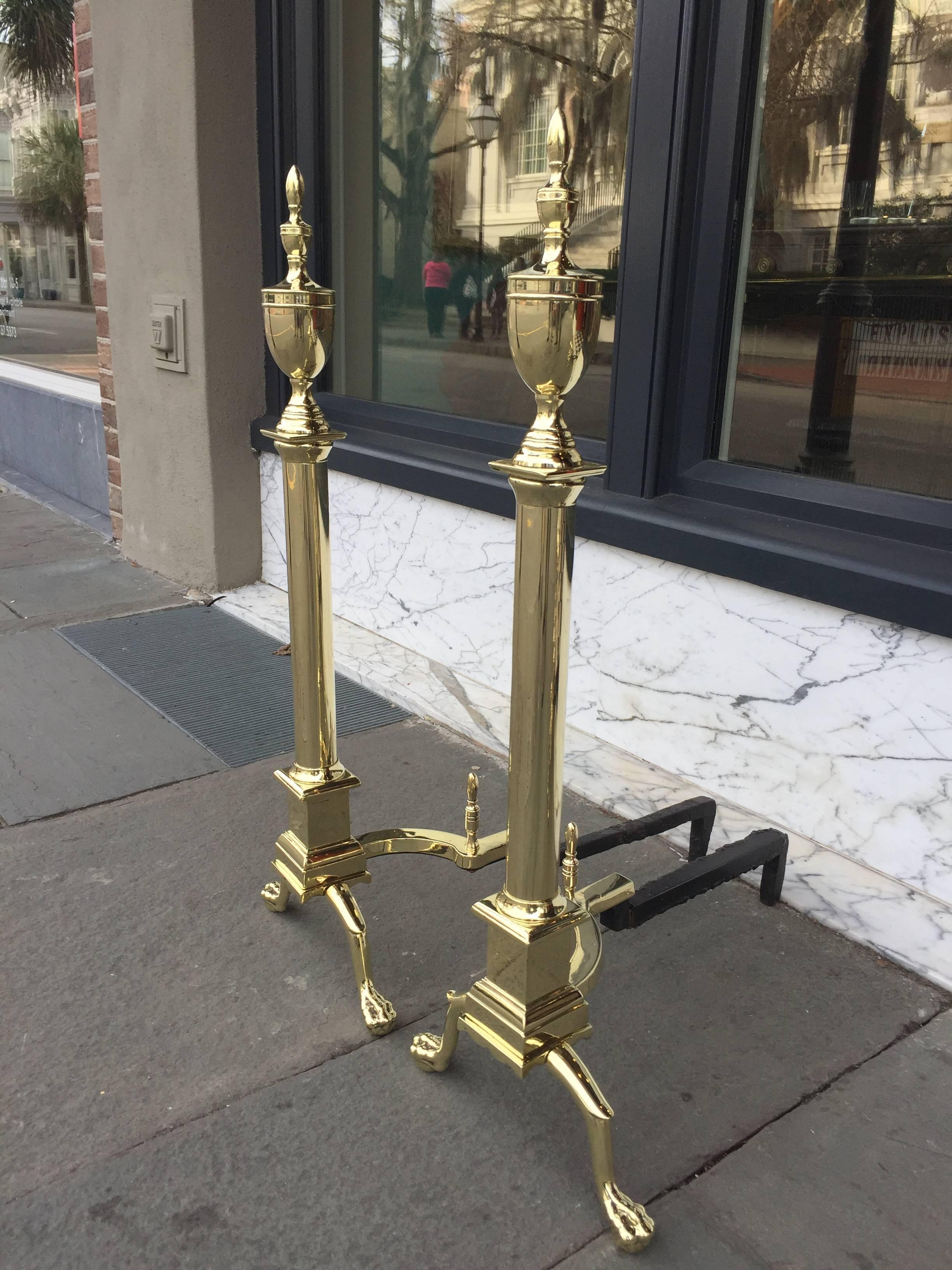 Pair of late 19th century brass urn form andirons with logstops.