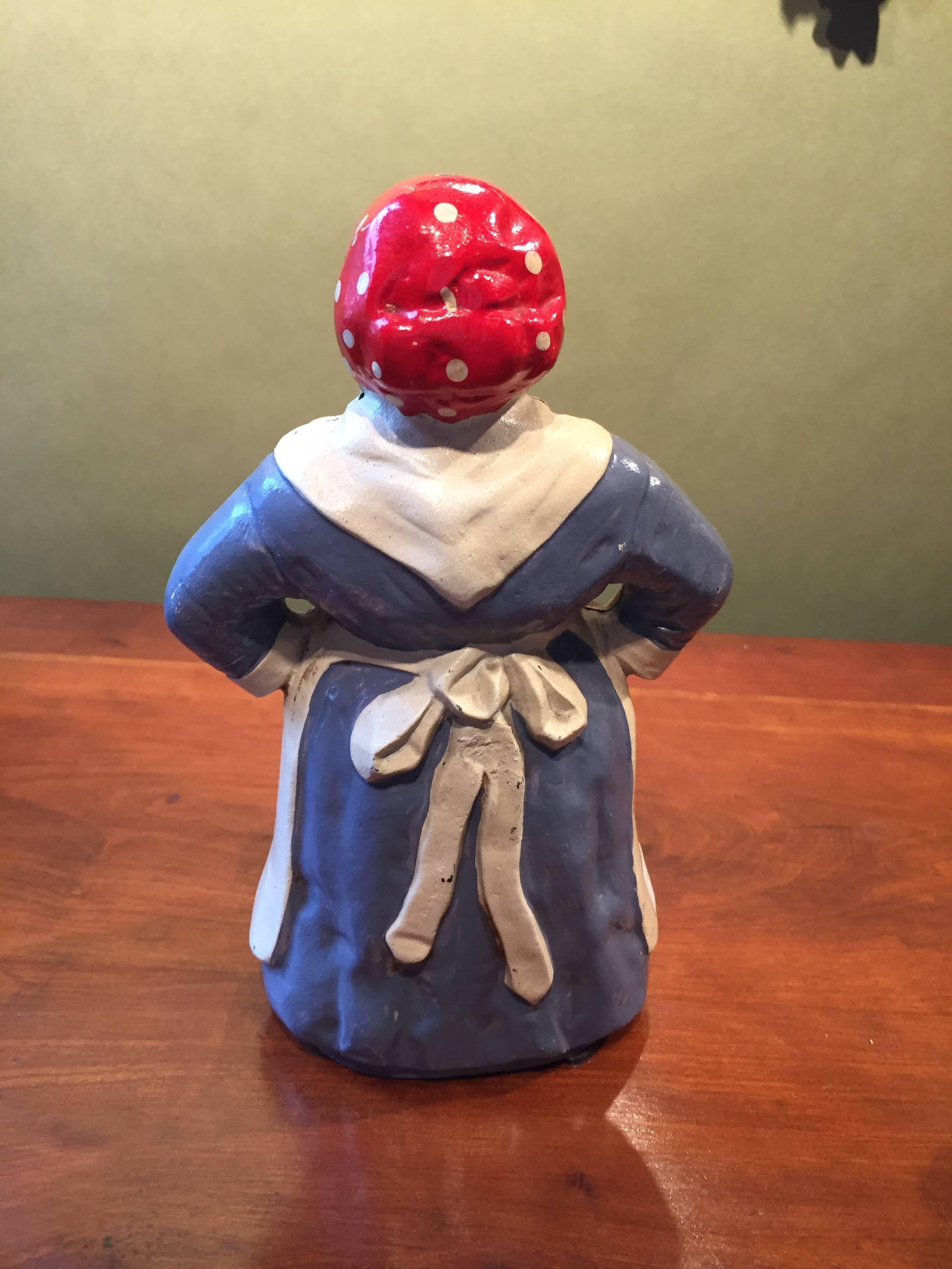 Early 20th century cast iron door stop in blue and white paint.