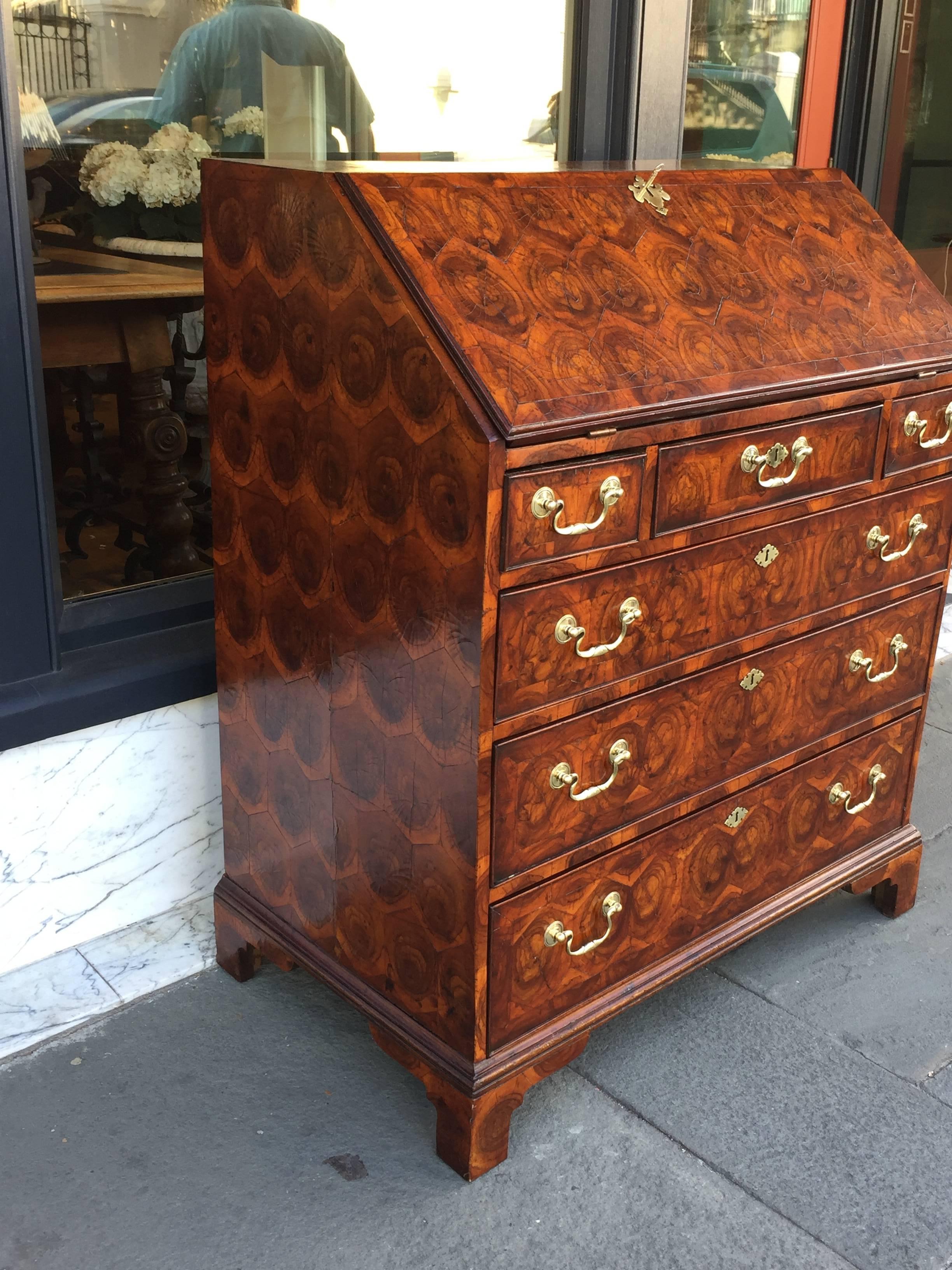 Walnut veneered slant front desk with highly figured oyster veneer surface.