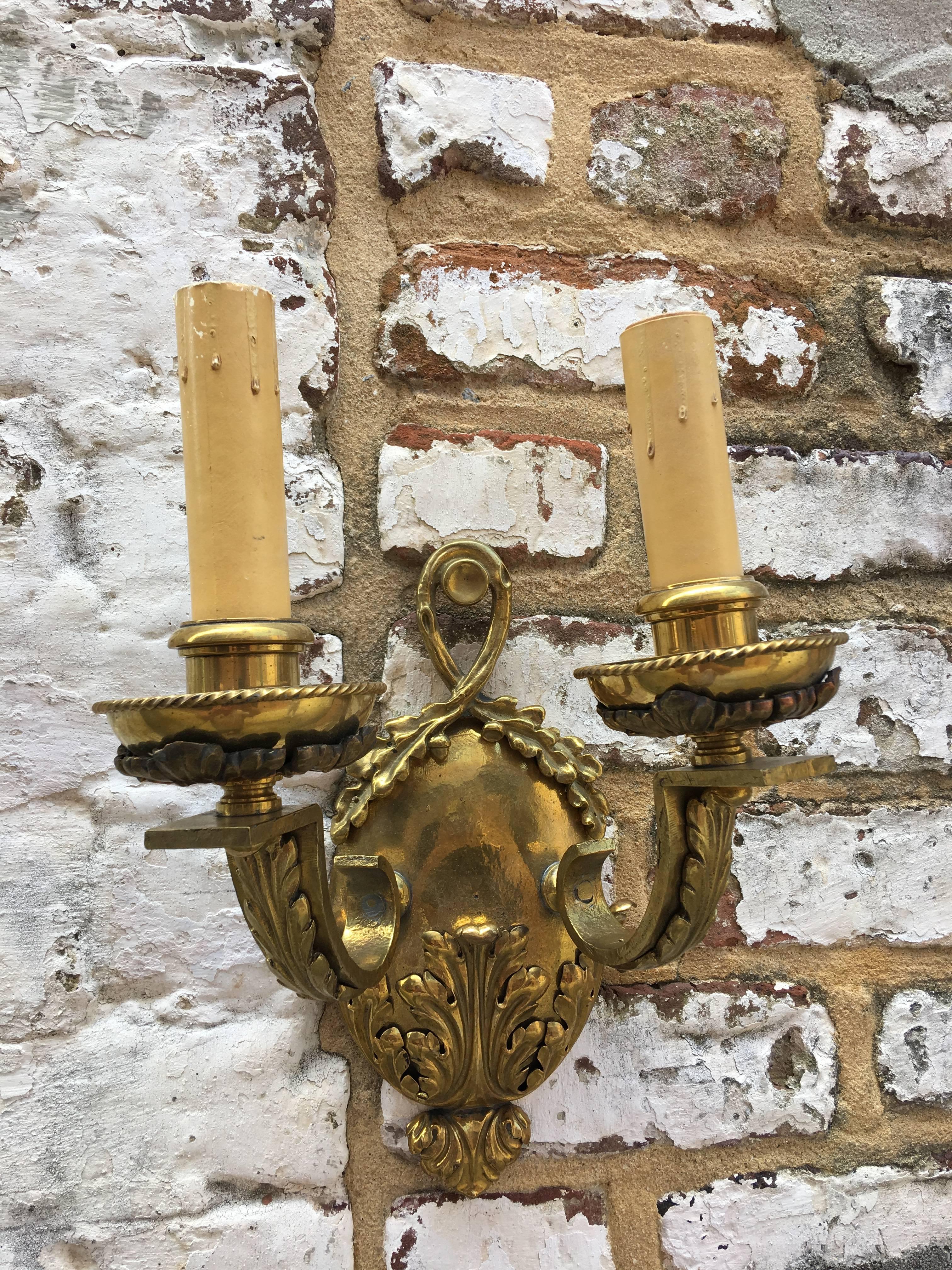 Pair of English ornate double arm brass sconces.