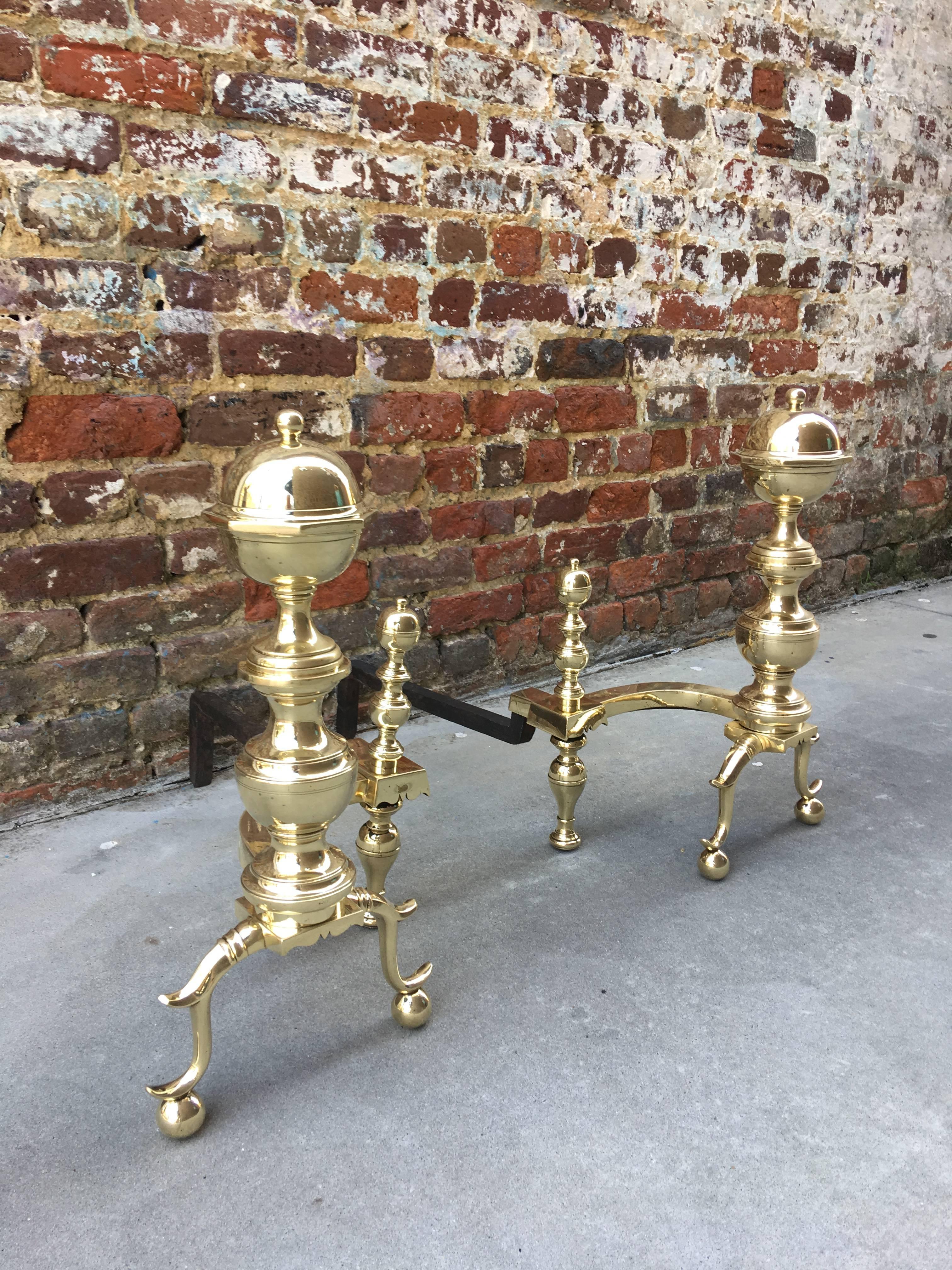 Pair of brass andirons with large log stops, mid-19th century.