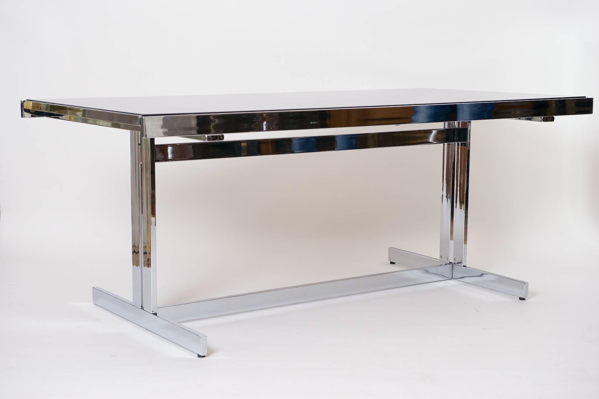 Chrome and glass extending dining table.

Close to pristine condition.