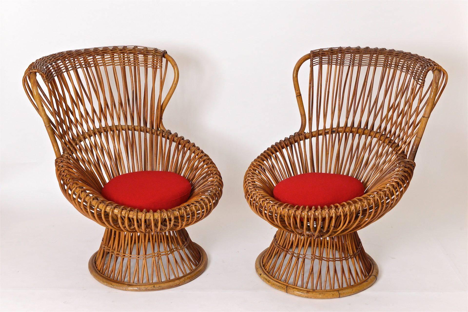 Pair of Franco Albini rattan chairs. Lovely ageing to rattan and in wonderful condition. Seat cushion re upholster in red wool.

The chair design won the 9th Milan Triennale in 1951

