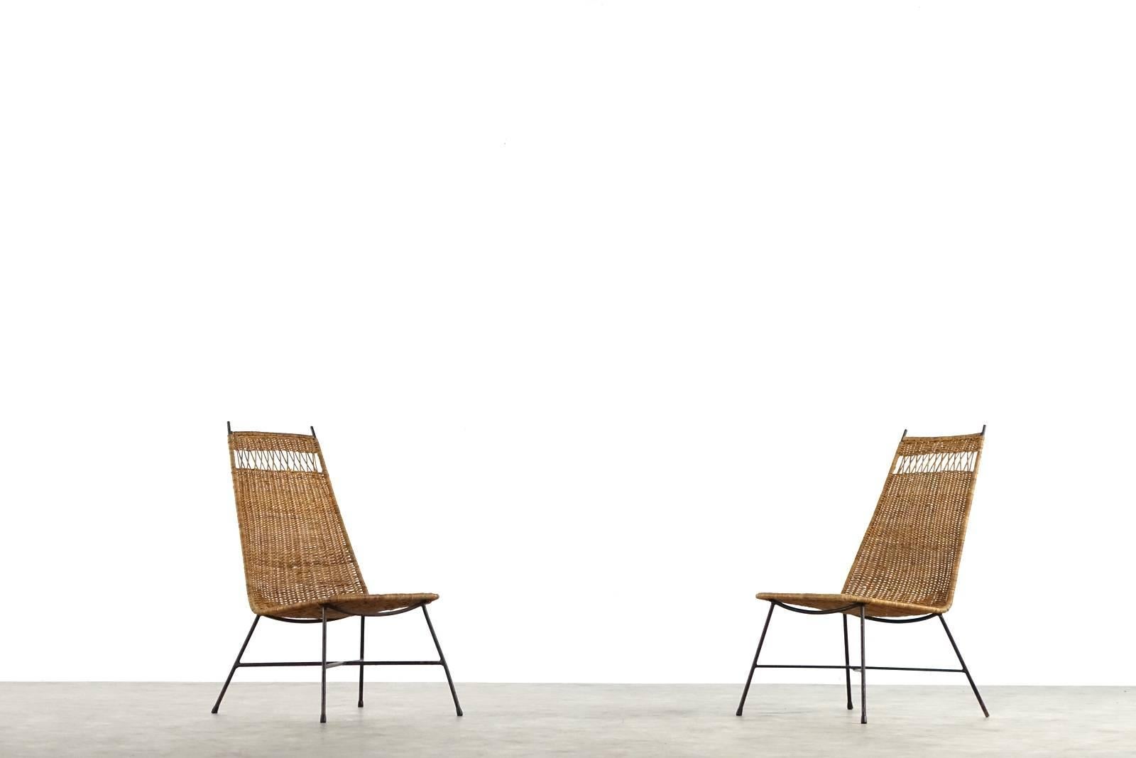 A nice pair of Mid-Century Modern wicker basket lounge chairs from

France. Imperfections in the weave.