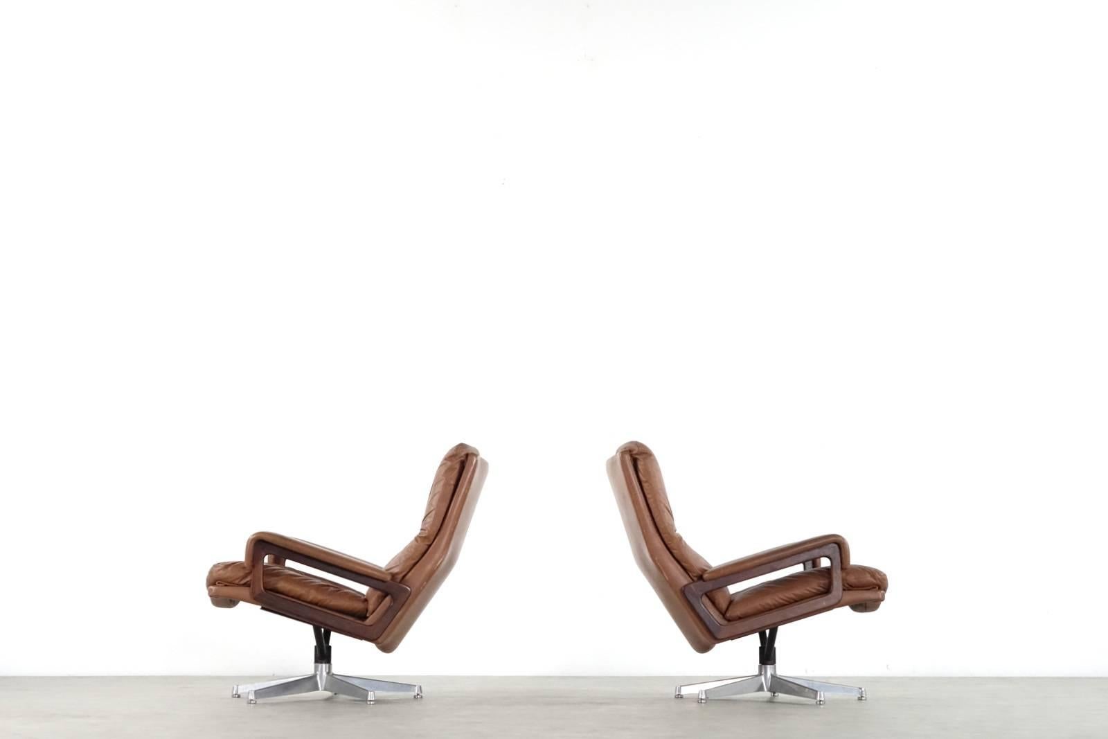 Pair of King chair design Andre Vandenbeuck for Collection Strässle Internat.

Incredibly high-end craftsmanship and sophisticated details with rosewood armrests. Partly filled with down feathers which makes the King chair very