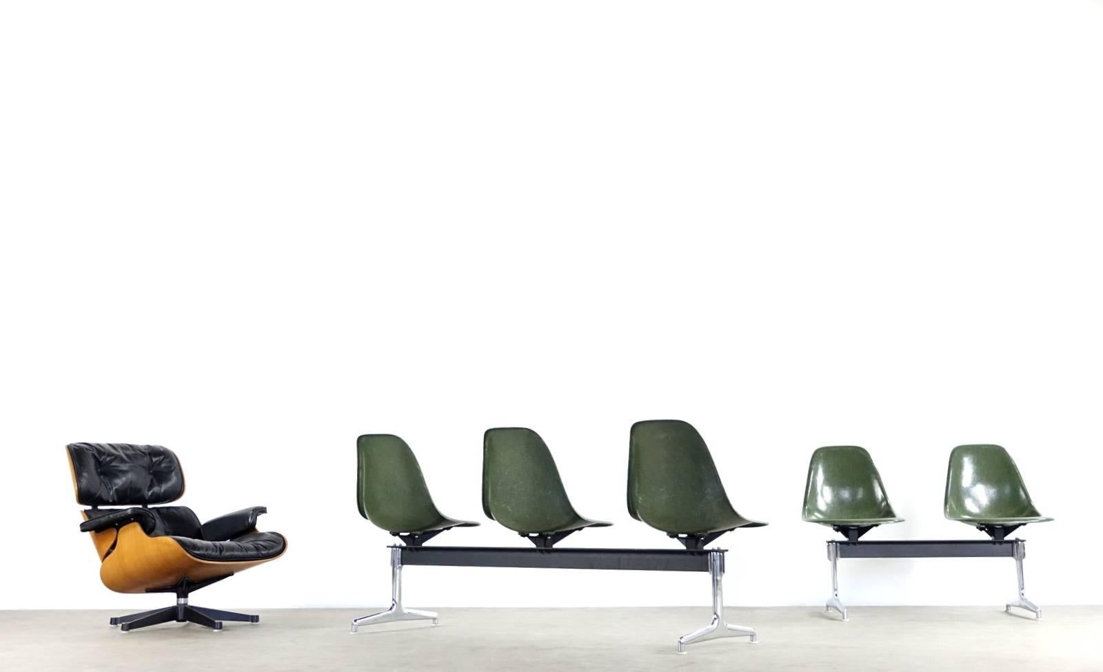 A rather rare and very cocky tandem shell seating designed by Charles & Ray Eames for Herman Miller, USA in the 1960s. The seating has three seats in green fiberglass with a chromed and black metal base.