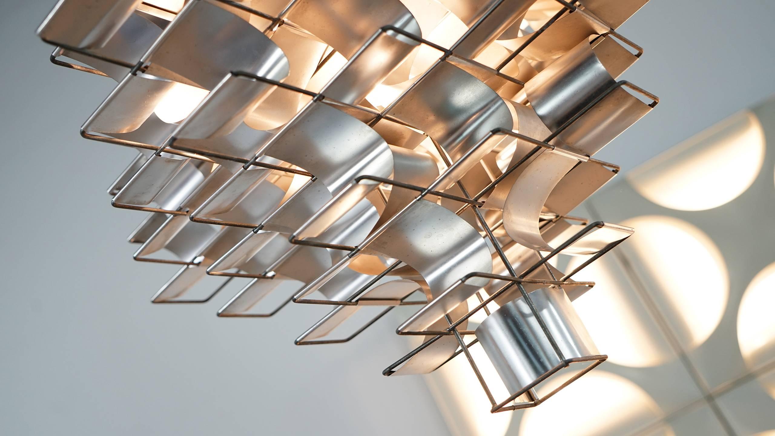 Chandelier in aluminium, by Max Sauze, France, 1970s. 

Large Cassiope´e chandelier in aluminium and steel by French designer Max Sauze. 

This light has been build up on a steel frame combined with bend aluminium leaves to provide a symmetric