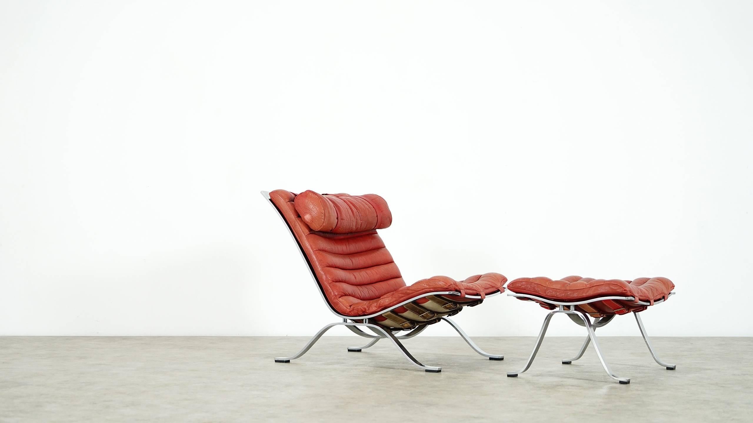 Fantastic comfortable lounge chair with its footstool...

Designed by Arne Norell for Norell Möbel, Aneby Sweden 1966.

This award winning lounge chair was made of high quality flat chrome plated steel and has very thick red or orange buffalo