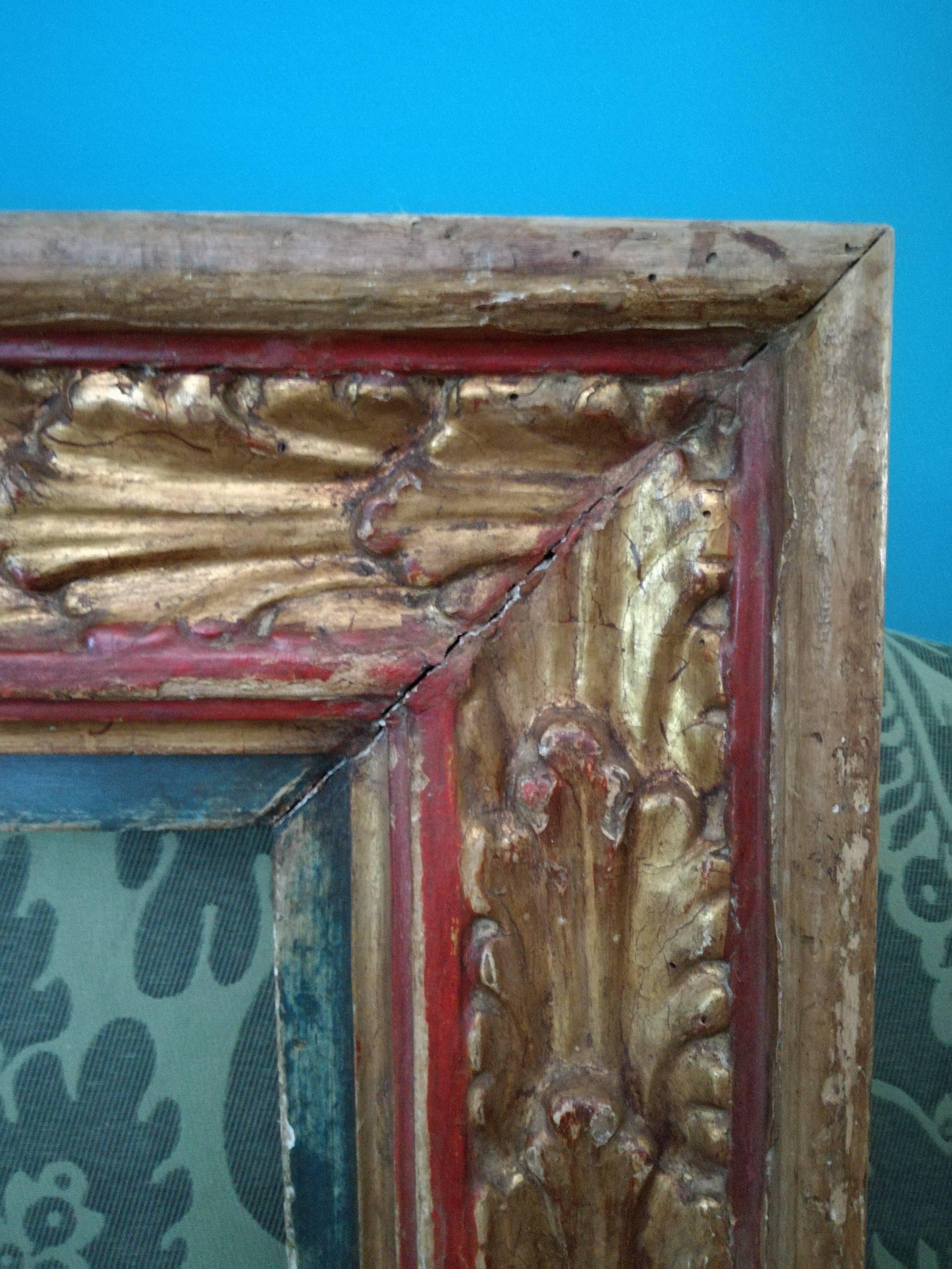 Wooden picture frame decorated with a leave pattern.