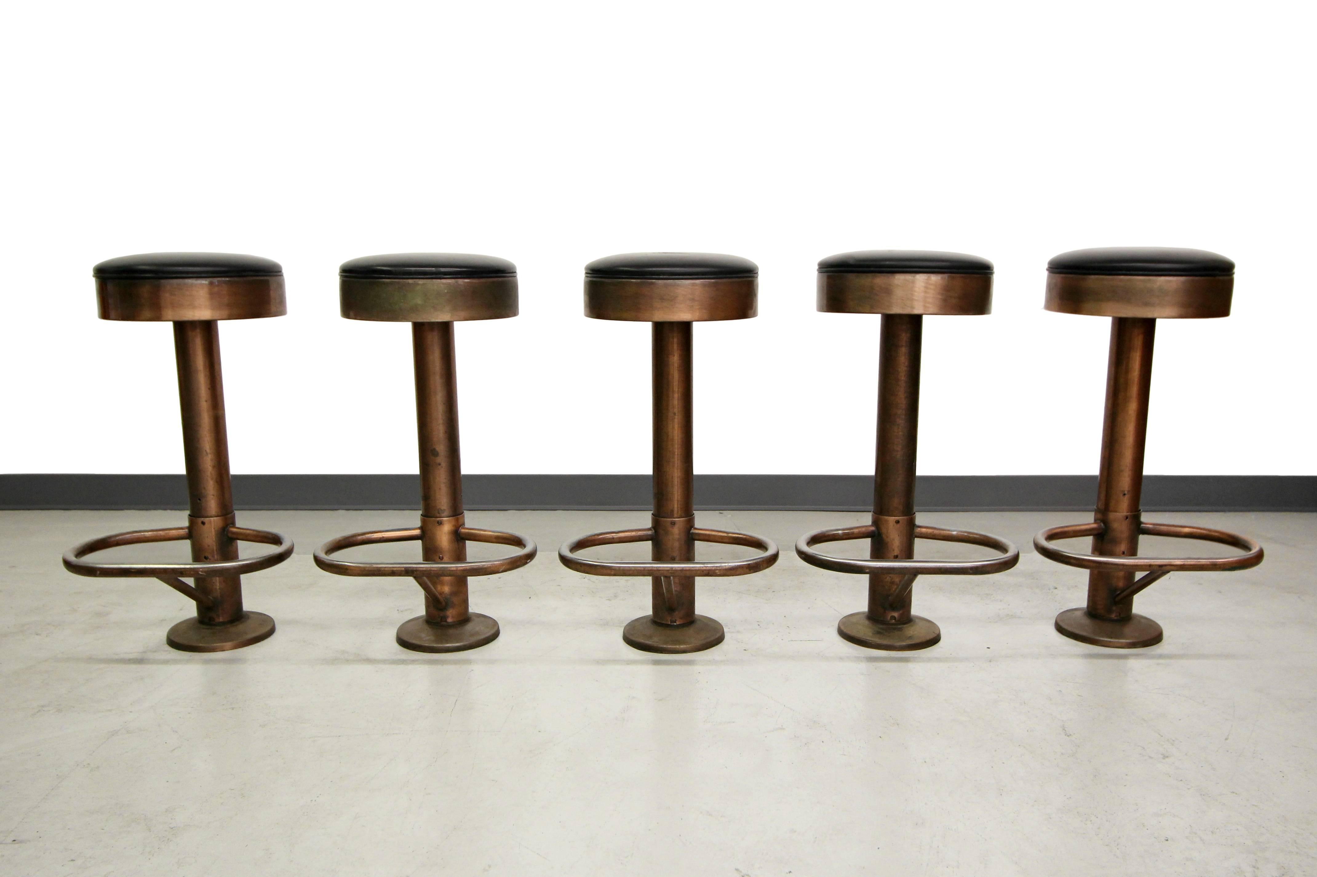 Set of five Industrial Machine Age style column counter stools. Stools have a great Industrial look. They are copper finished, but some of the copper has worn off from use, giving them a great worn, Industrial vibe. These would be perfect counter