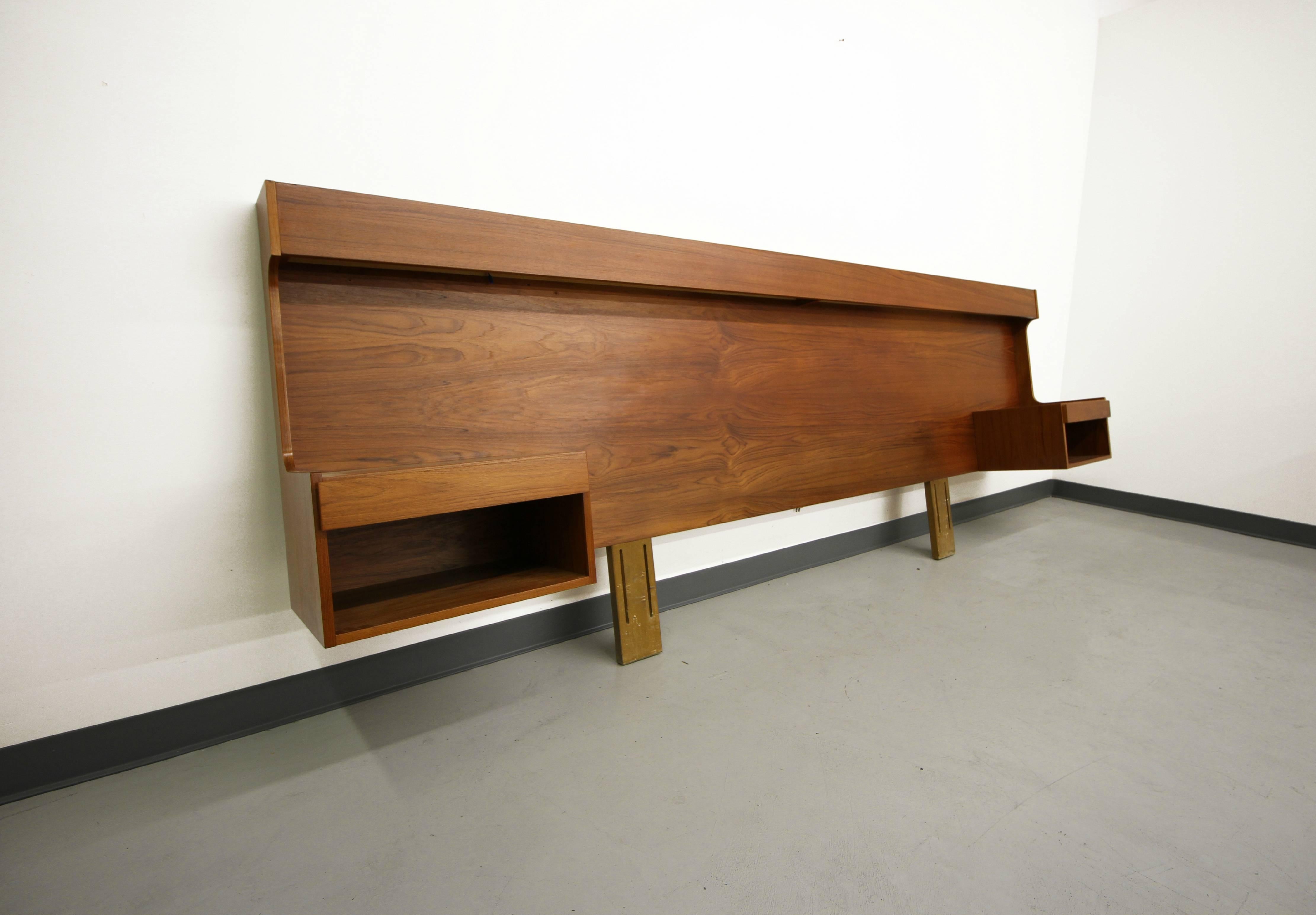 This a rare king-size Mid-Century Danish teak headboard with floating nightstands. The headboard also features hidden lights for your bed time working and reading needs. This headboard is large, and in charge, measuring almost 10ft wide, and ready