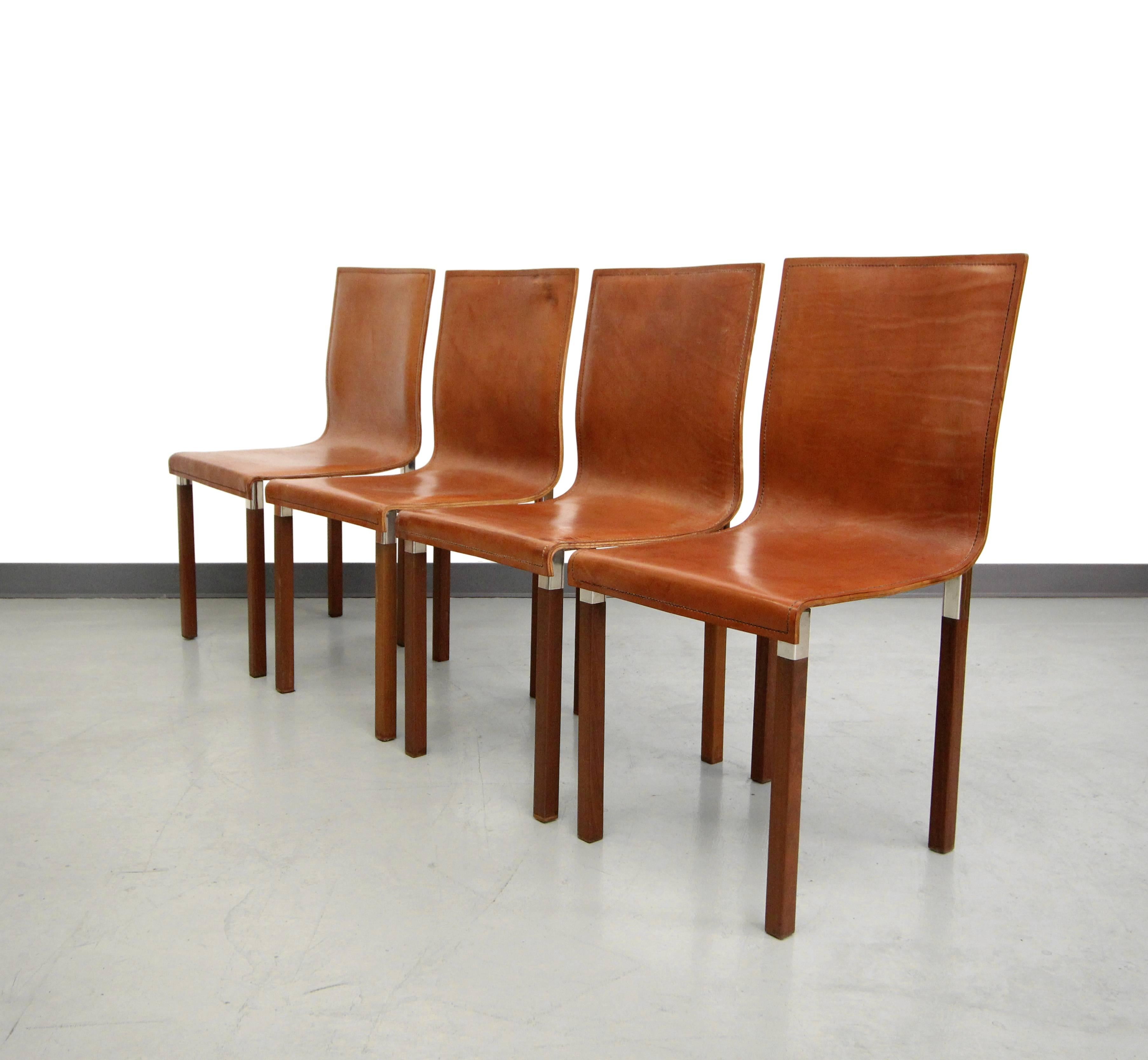Gorgeous set of four Emile chairs by Zele Company. The Emile chairs were designed with details and materials to reflect the Art Deco period. They are constructed out of double panel hand-stitched saddle leather upon solid wood legs with polished