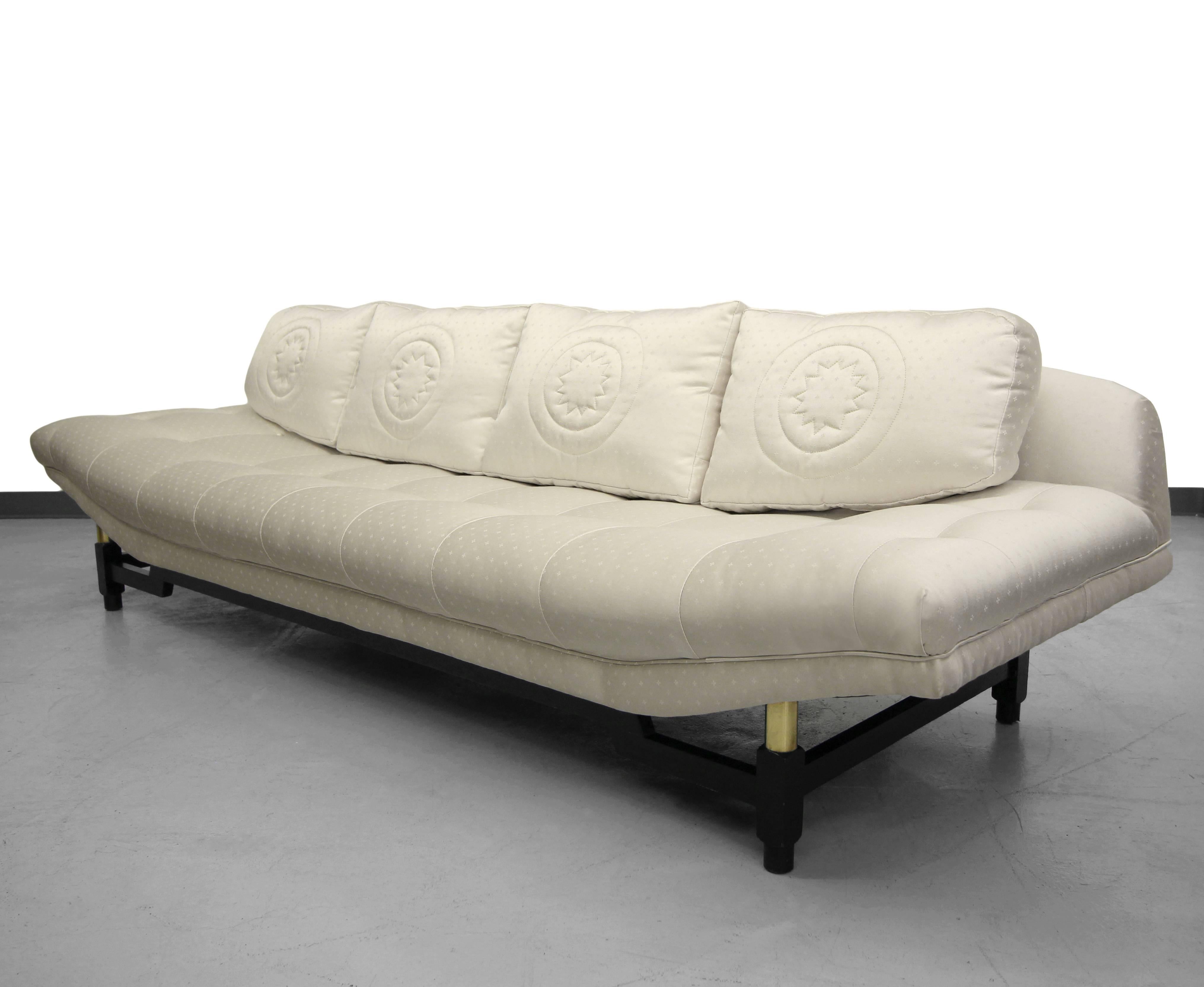 Mid-Century Gondola sofa by Baker Furniture.  Sofa has super clean lines with a bit of Asian flair. This beautiful sofa is unlike any other gondola sofa. 

Base is tubular wood finished in black lacquer with brass details. Fabric is a vanilla