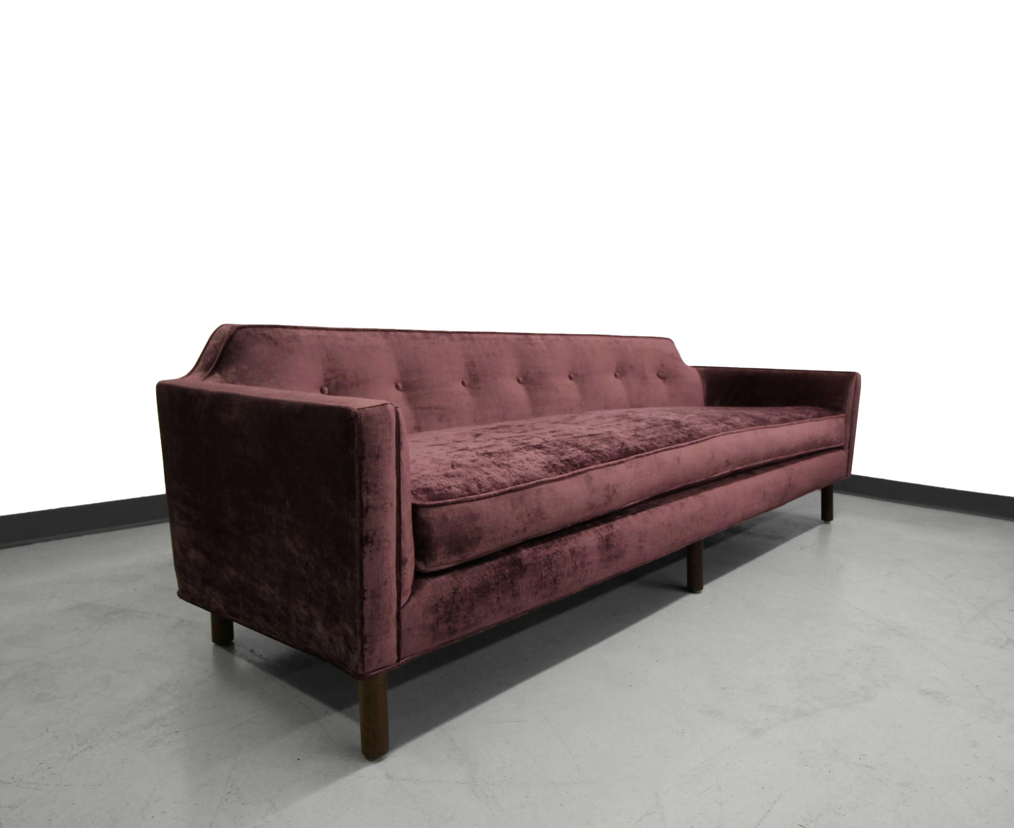 Absolutely gorgeous curvevd back sofa by Edward Wormley for Dunbar. Expertly finished in a plum colored velvet. Sleek, sophisticated with lines to die for.

Sofa has been reupholstered with all new foam and fabric.
