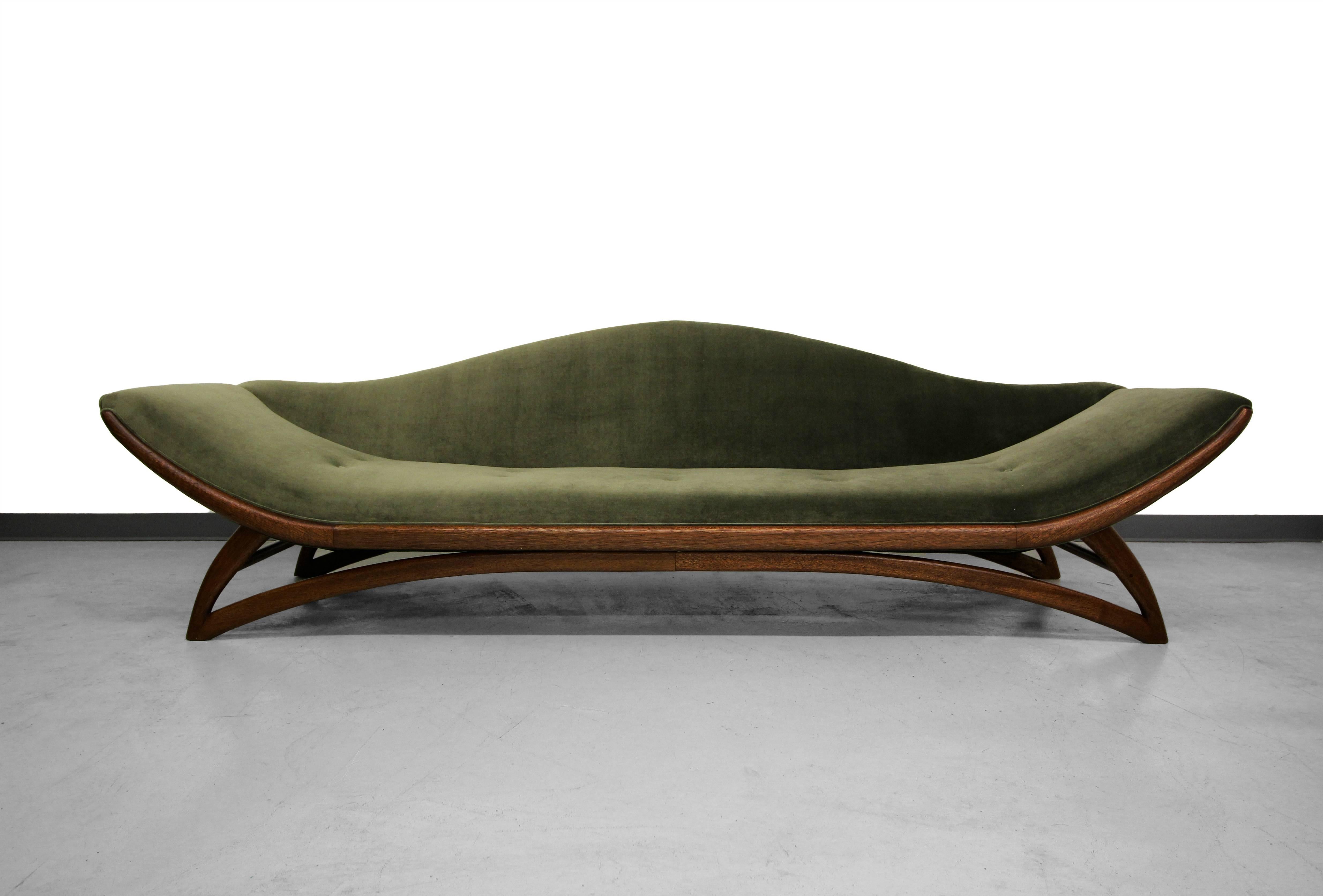 Absolutely stunning Mid-Century gondola sofa. Amazing lines and details make it a real show stopper. It measures 9ft in length and is supported by a perfectly sculpted walnut tone base. Expertly reupholstered in a gorgeous dark sage velvet with a