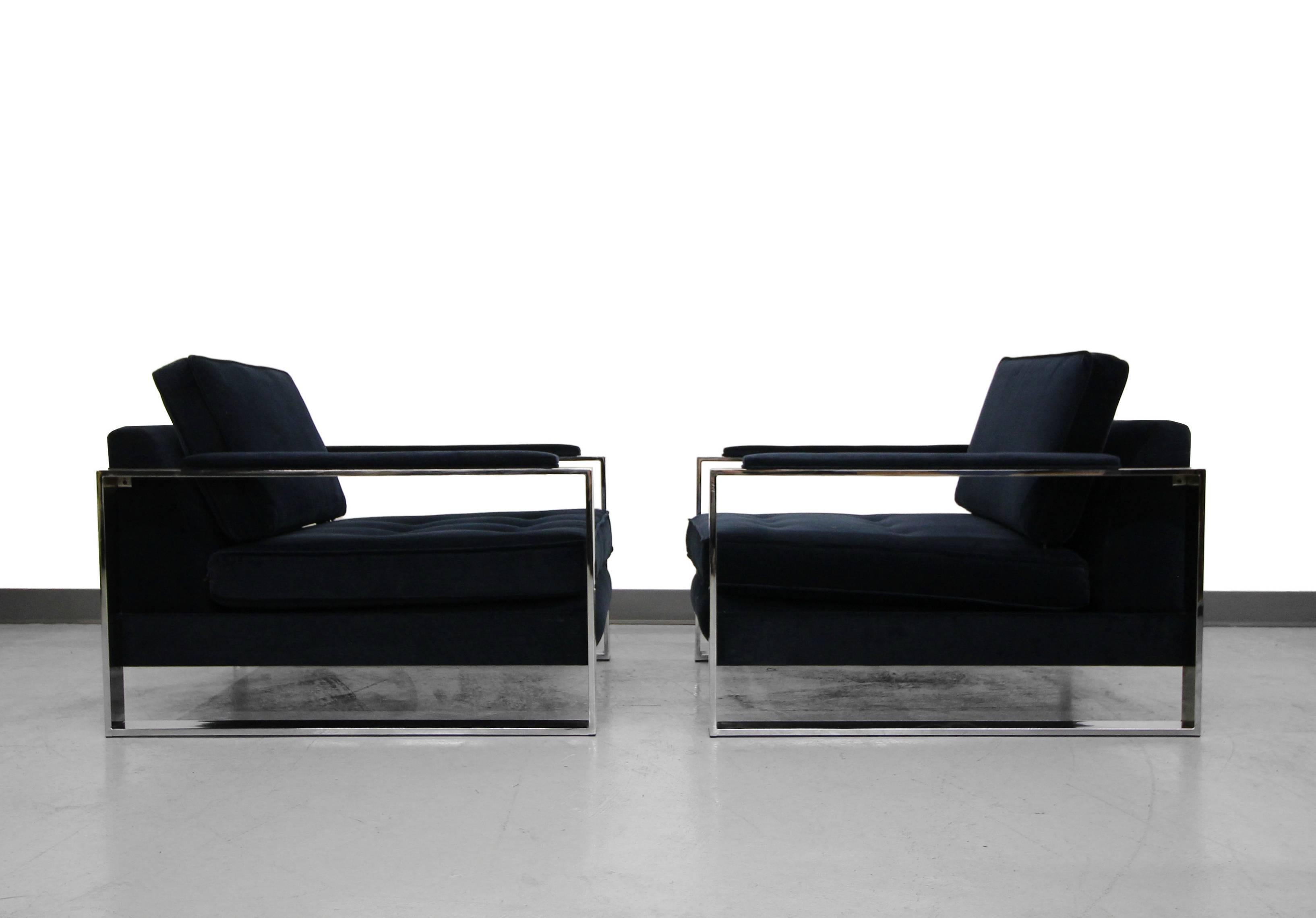 A perfect pair of oversized chrome Mid-Century lounge chairs by Milo Baughman. Floating on mirrored chrome frames and dressed in a dark navy crushed velvet, this pair is a handsome duo.

Matching sofa also available in a separate listing, see last