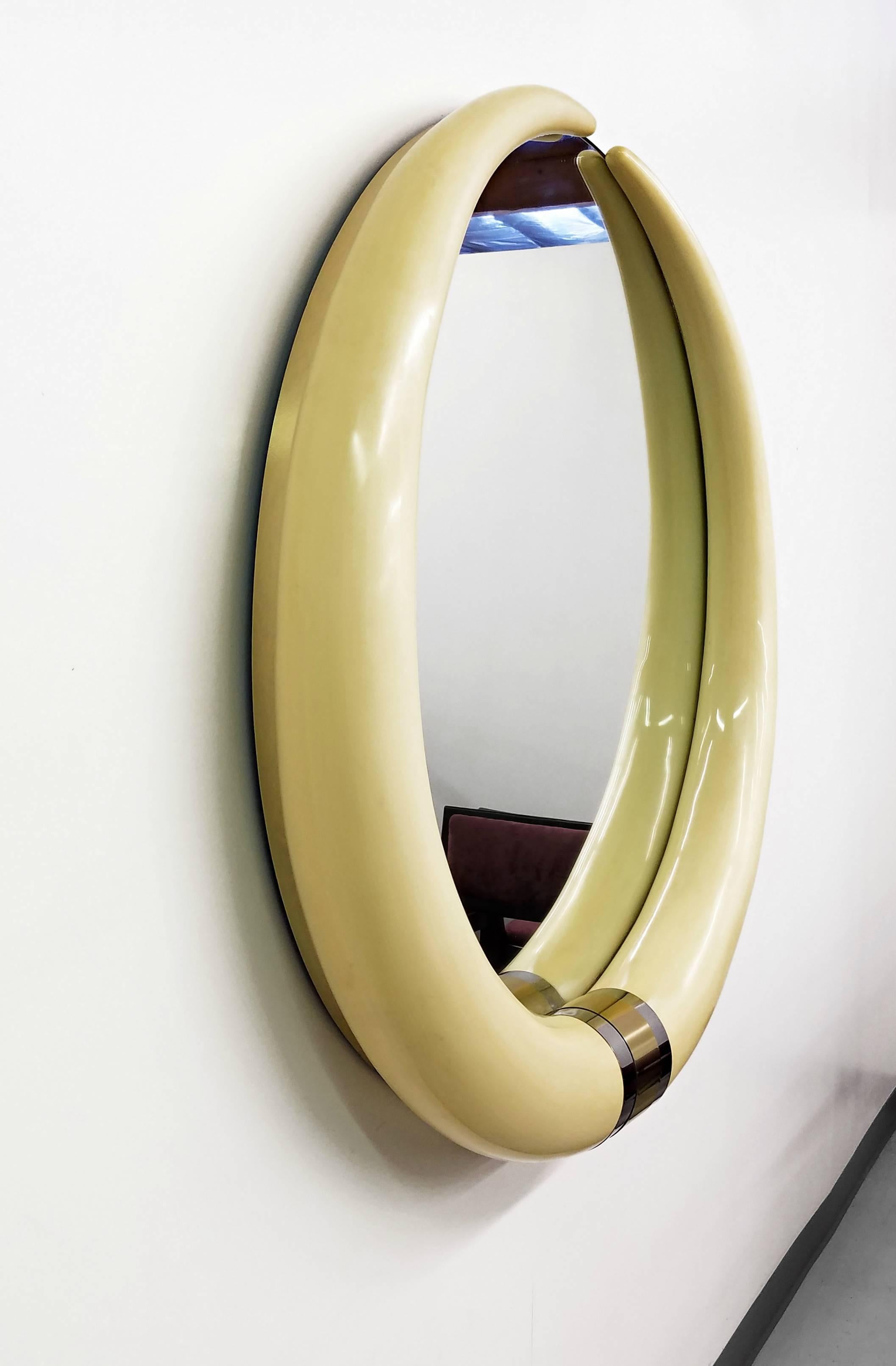 This huge tusk mirror is a real designer masterpiece. It measures in at just under 4ft in diameter, making it the perfect statement piece. Mirror features two faux tusks with a chrome and brass detail at the bottom. Mirror is expertly finished with