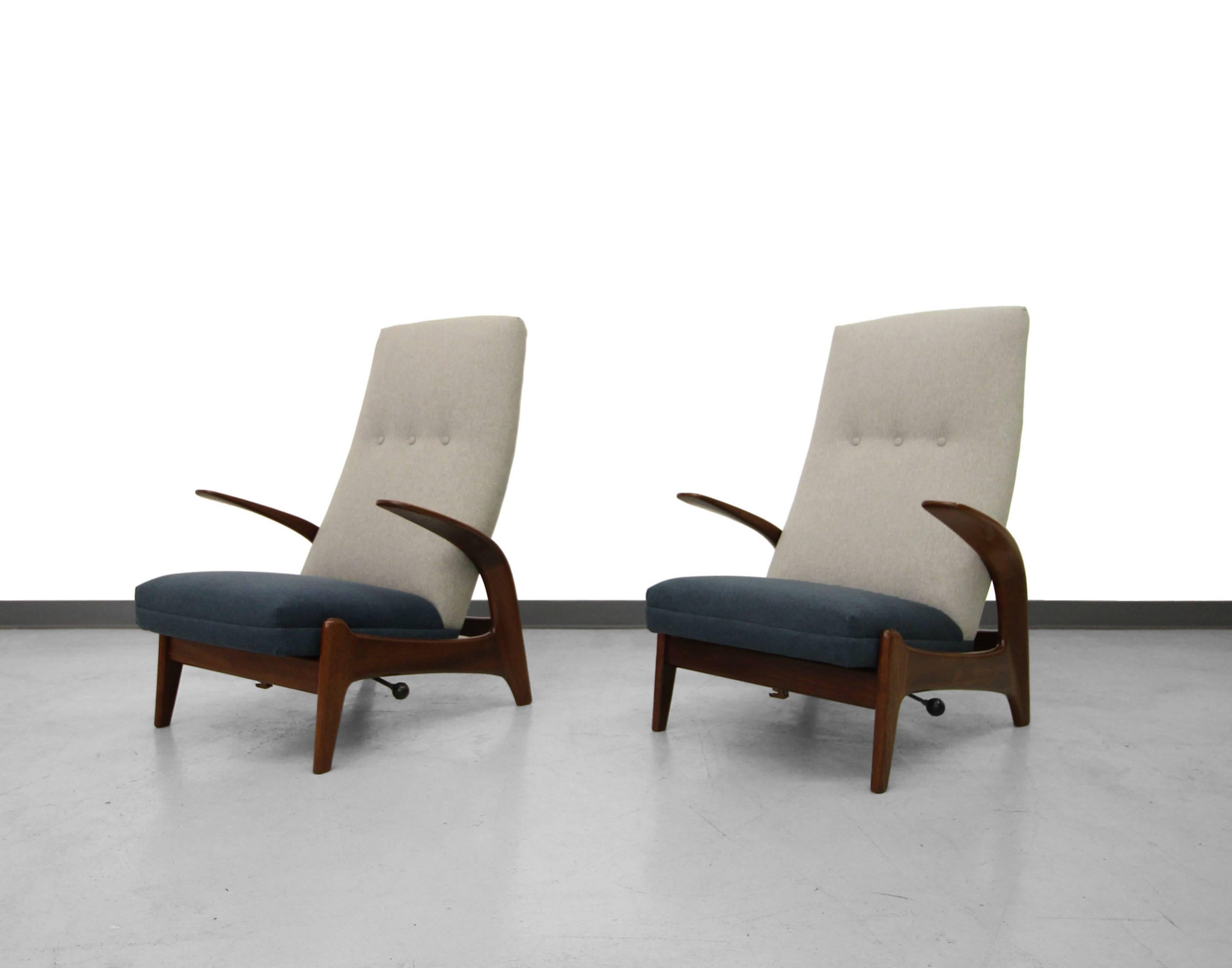 Absolutely stunning pair of high back, sculptural rocking reclining lounge chairs, designed in Norway and manufactured in the UK by Gimson Slater. Chairs feature a rocking and locking mechanism that allows the chairs to rock or be reclined in to one
