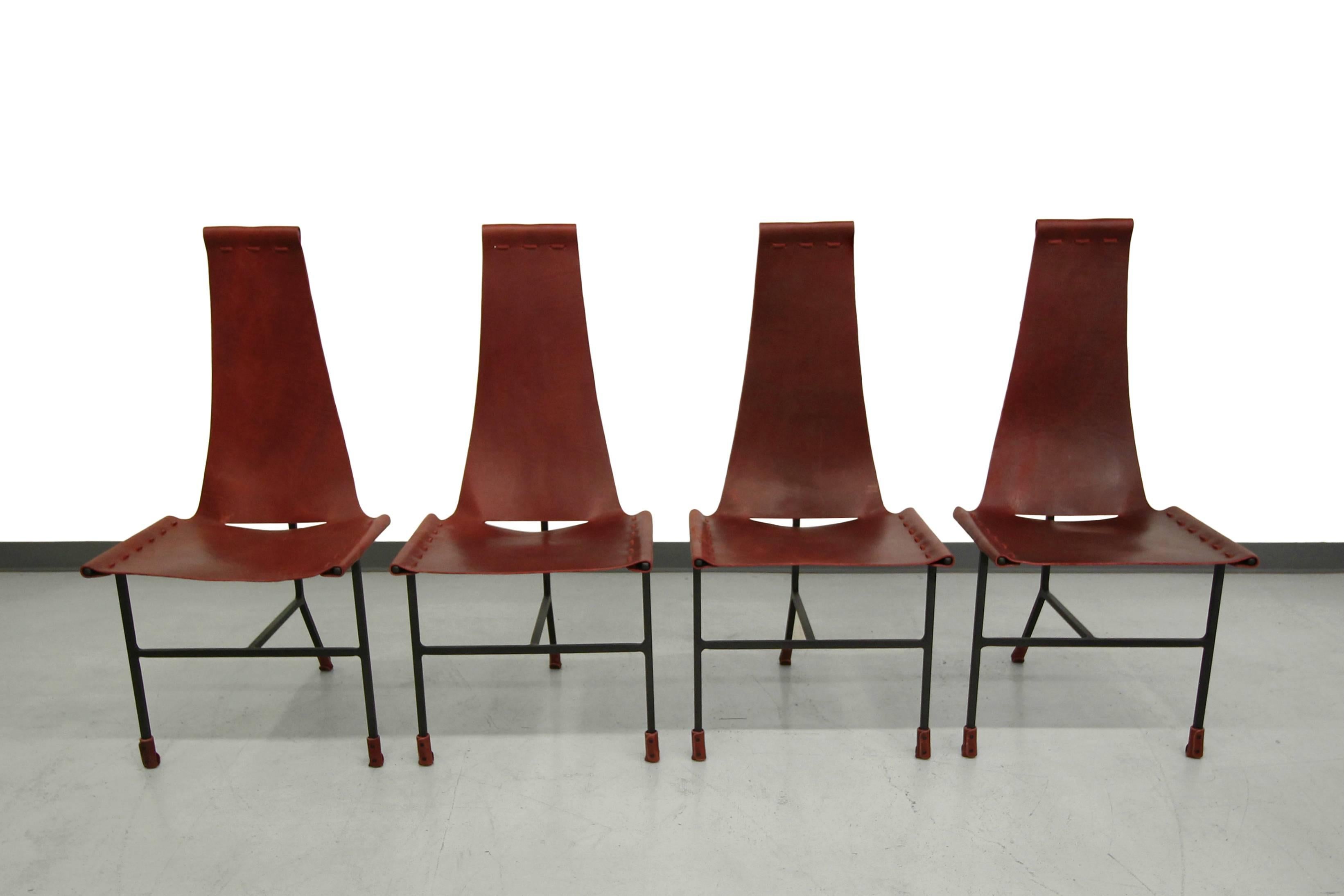 Beautiful set of Set of four Latigo leather dining chairs by Daniel Wegner. The leather slings are very nice, dark brick red. Chairs feature classic flat black, originally manufactured in the 1960s, these chair were brought back in to production in
