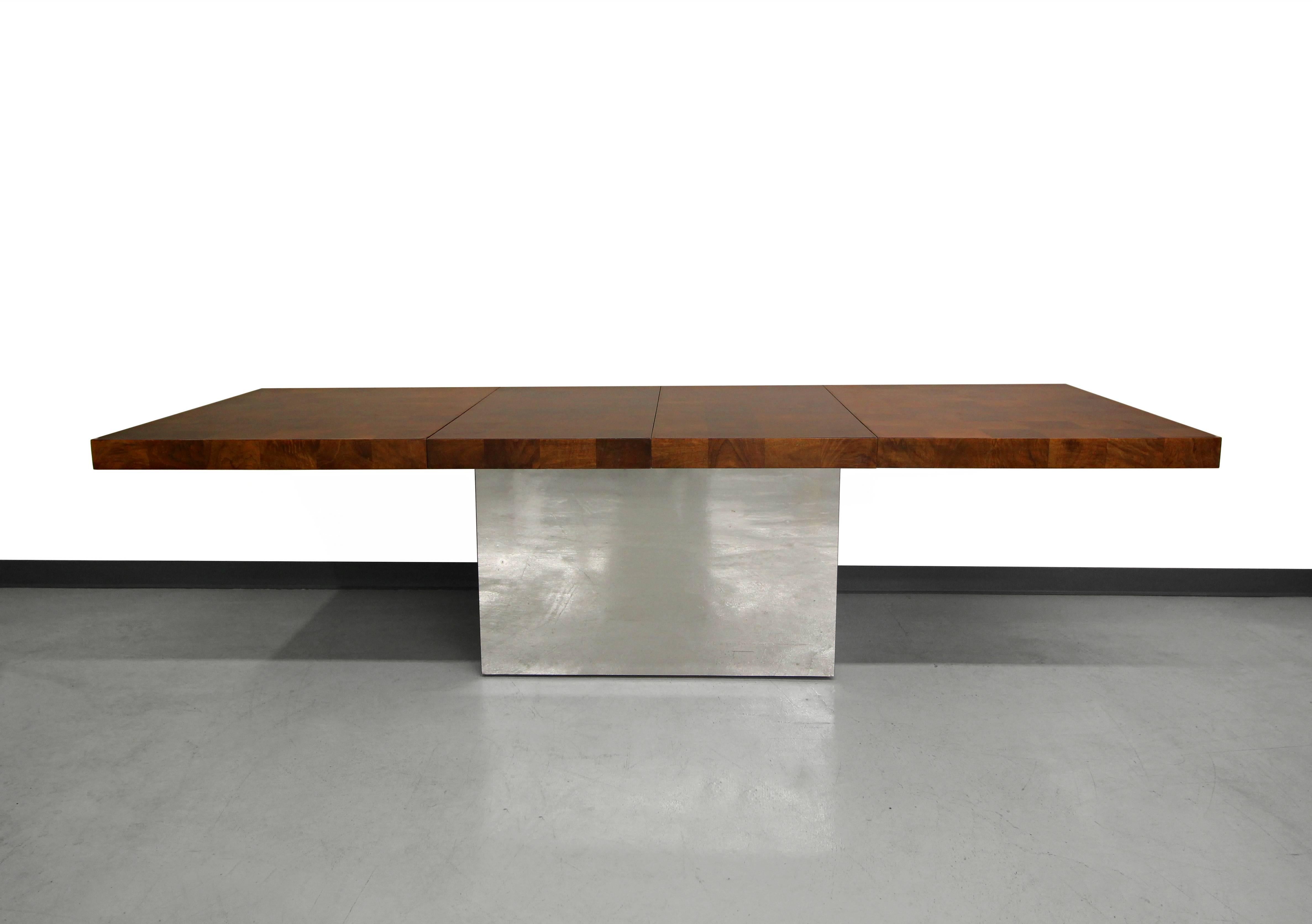 Huge and absolutely stunning patchwork burl dining table on a mirrored chrome pedestal base. Designed by Milo Baughman for Directional seemingly to mimic Paul Evans pieces of the same era. This dining table makes a statement and will be a real