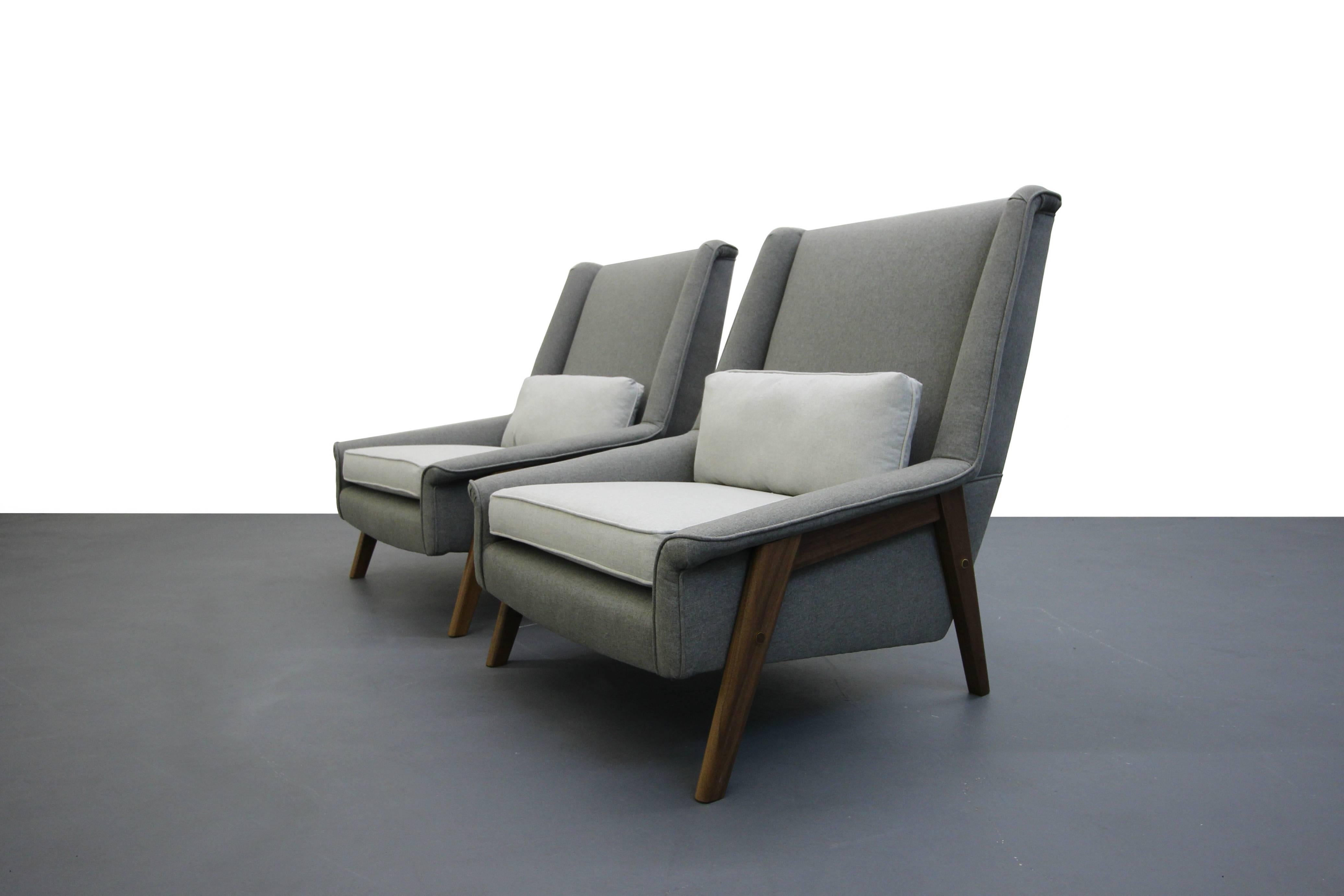 Beautiful pair of Mid-Century lounge chairs, professionally restored in a beautiful, soft, tone on tone gray fabric updating them from your grandma's chairs, to a gorgeous pair that can be incorporated into a multitude of decors. These chairs are