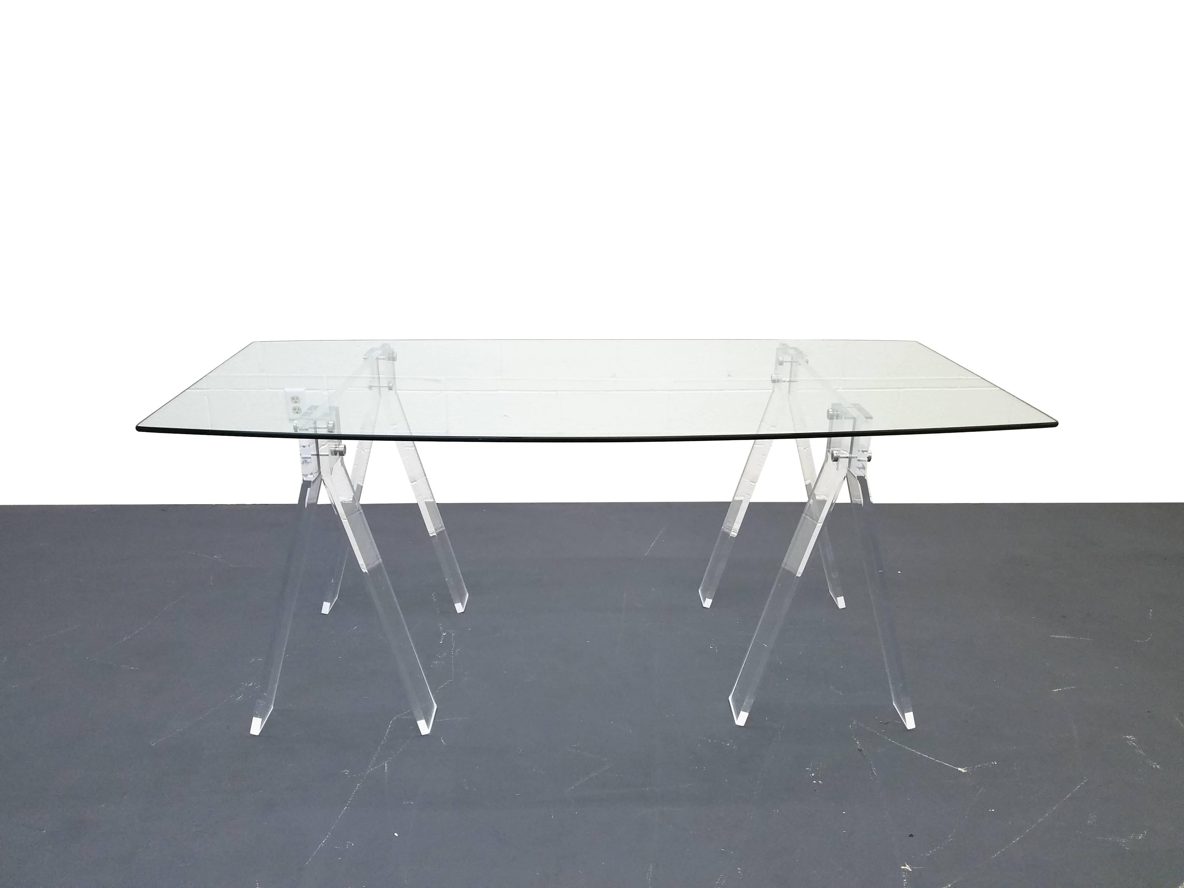 Mid-Century pair of Lucite saw horses, seen here as a desk or small dining table with a rare piece of boat shaped glass. When it comes to simple, minimal design, Lucite is it, combine that with a gorgeous piece of glass and you have a win/win