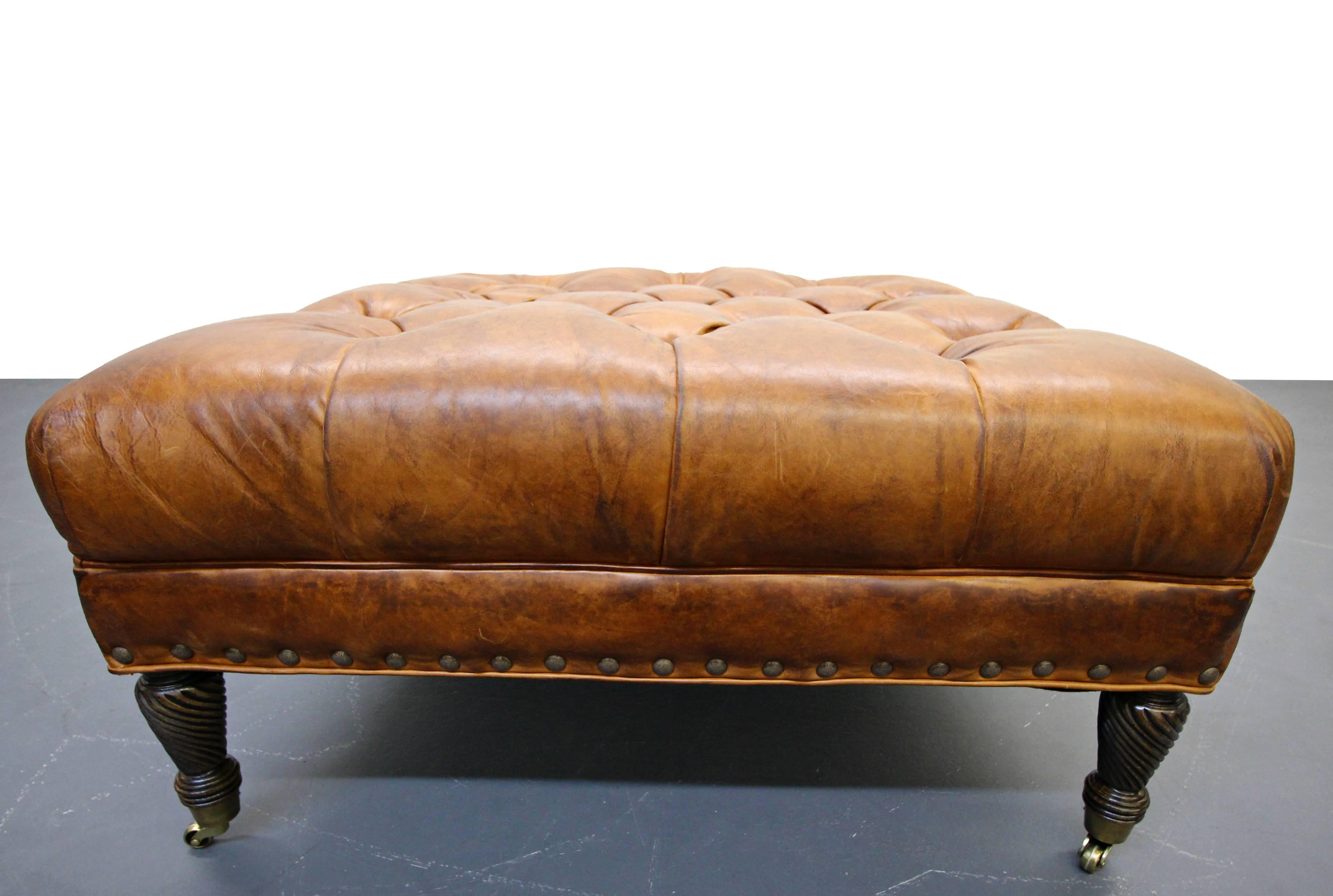 Beautiful tufted leather ottoman with gorgeous patina to the leather. This ottoman is the picture perfect accent piece to any living space. It would make a great coffee table or accent bench. It is a beautiful caramel color brown with small brass