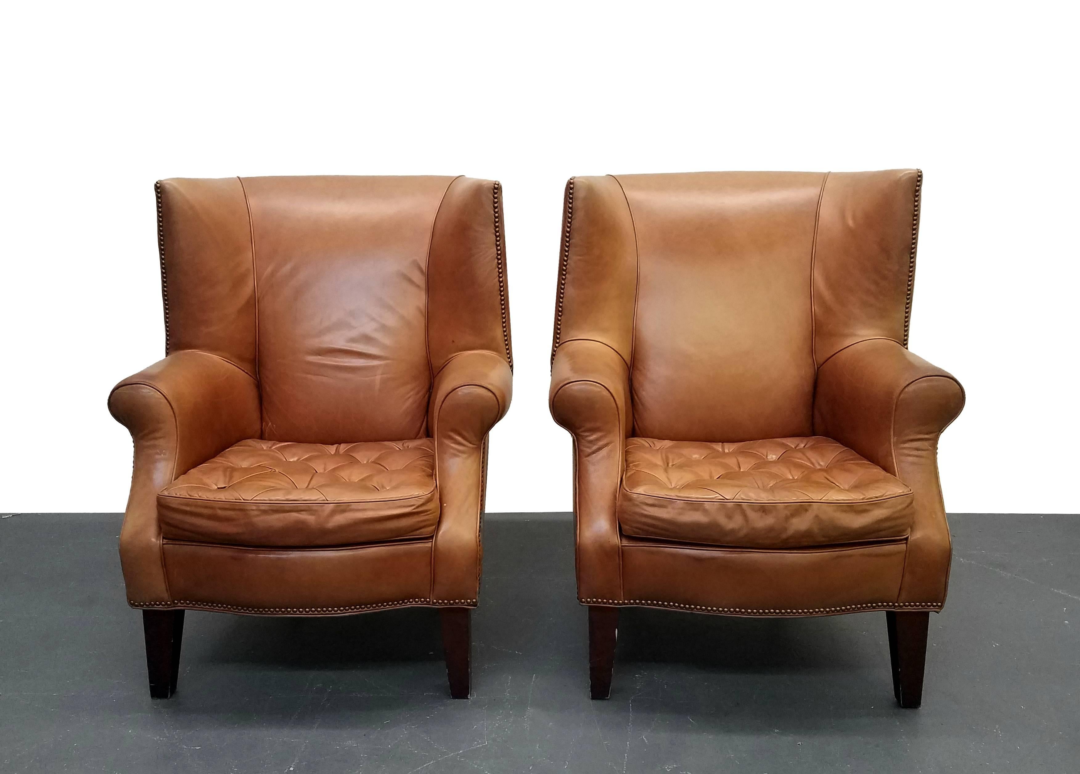 This is a great pair of large vintage worn leather wingback chairs. Perfect for a library, man cave or cigar bar. These beasts ooze, manly. They are oversized and comfortable with the perfect patina to the leather. Leather is gently worn but not