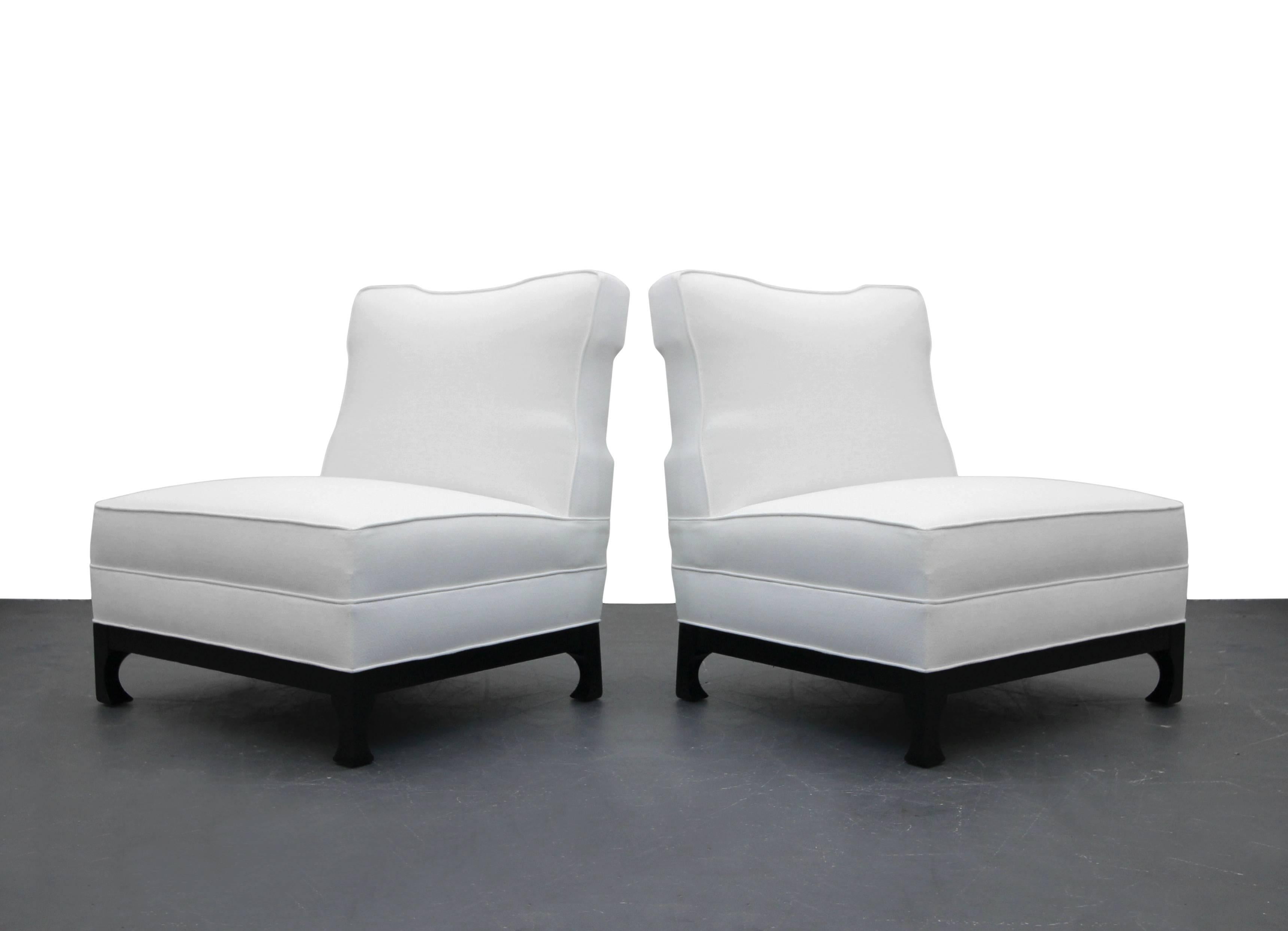 Absolutely stunning pair of Asian style slipper chairs by James Mont. These chairs are wonderfully sized with beautiful details.

They have been expertly restored with all new foam and fabric in a beautiful white woven tweed on sculpted black