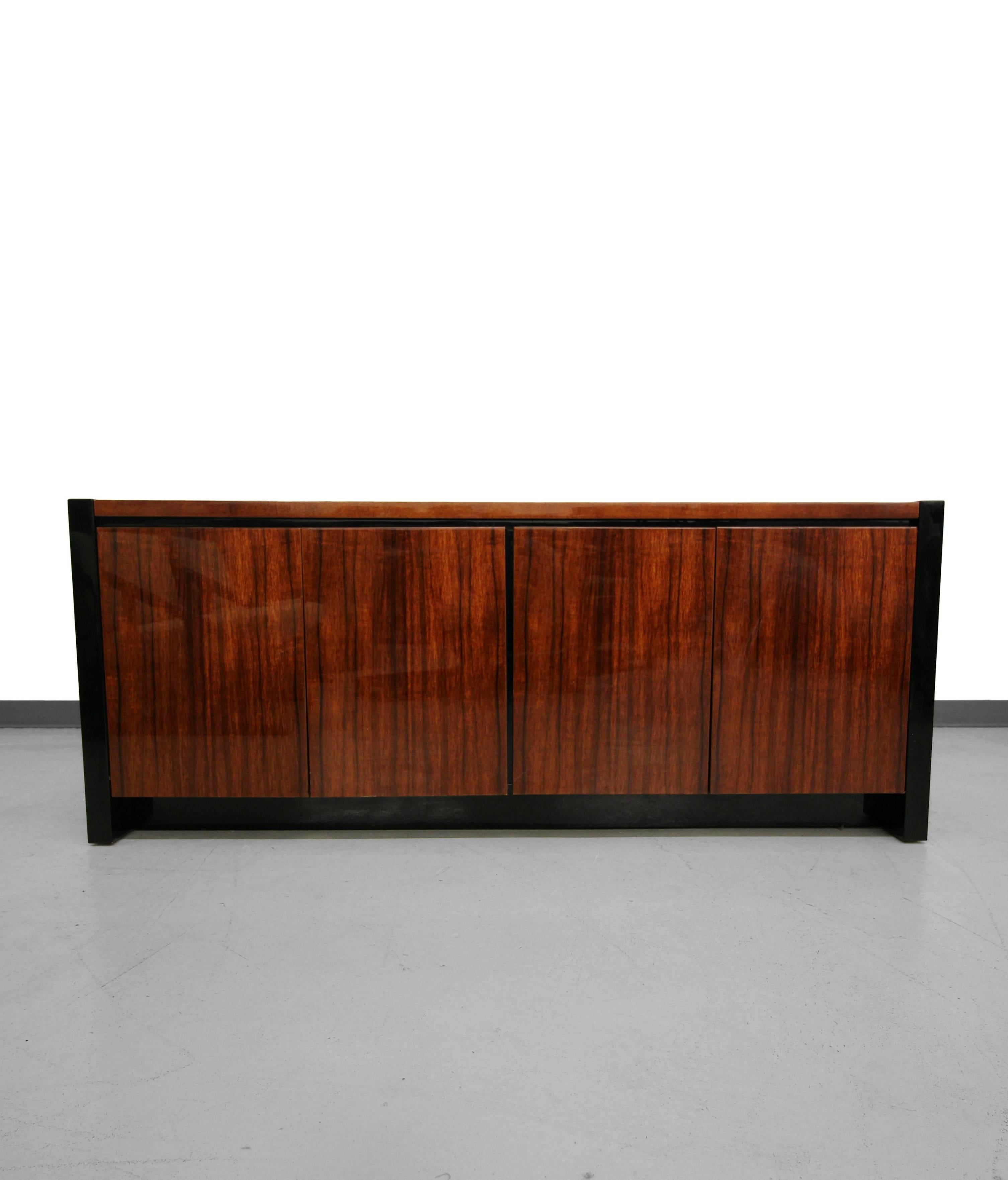 Absolutely stunning black lacquer and Koa wood credenza by Henredon for their Elan collection. This is a jaw dropping piece of very versatile piece of case work. It can be used as a buffet, credenza, entertainment cabinet or anywhere you're looking