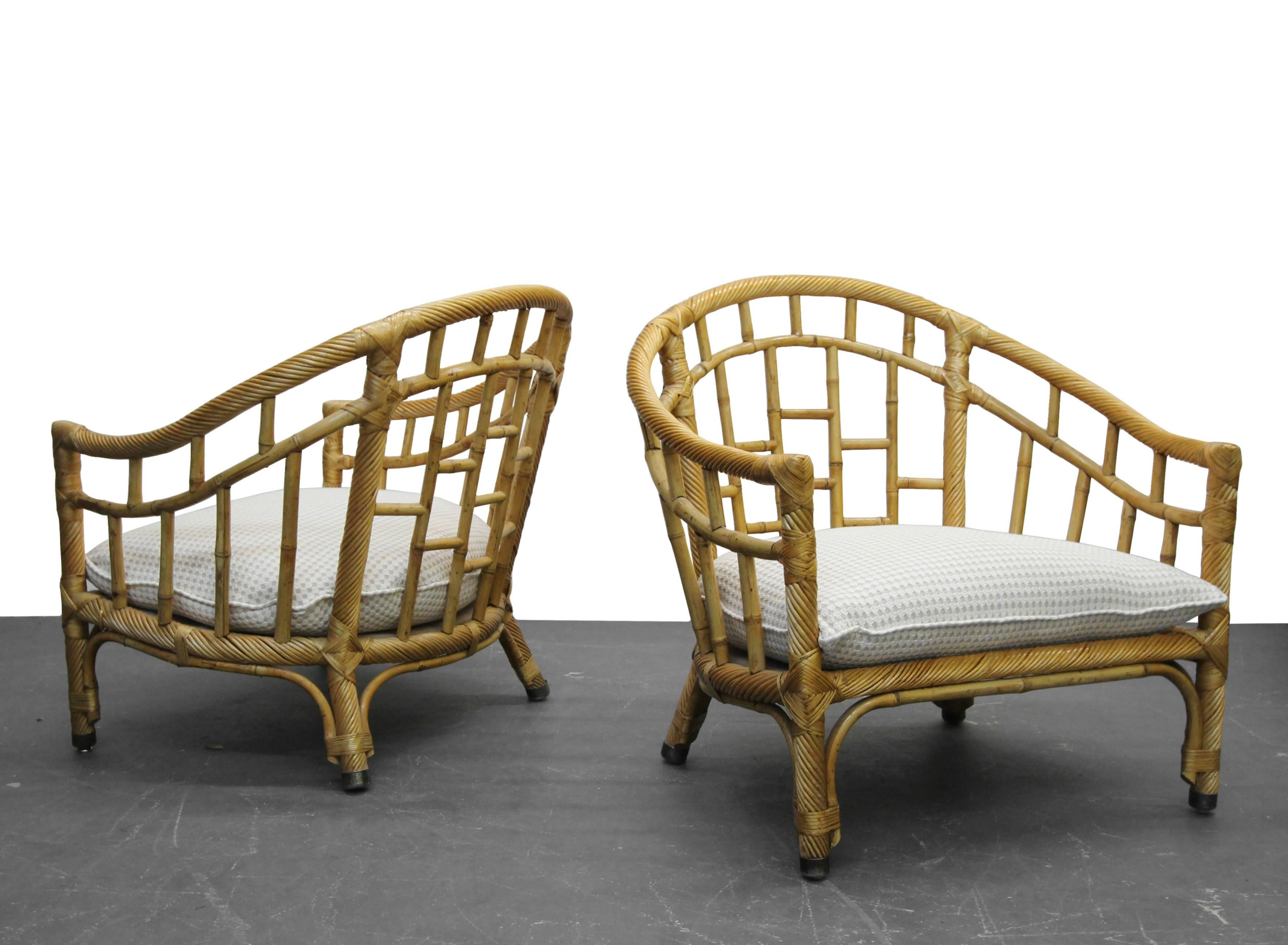 Rare oversized pair of barrel back bamboo lounge chairs. Perfect chairs for a Bohemian or eclectic decor. Would make perfect sun room or reading room chairs.

Bamboo and rattan is in excellent condition. Chair has all new strapping and down filled