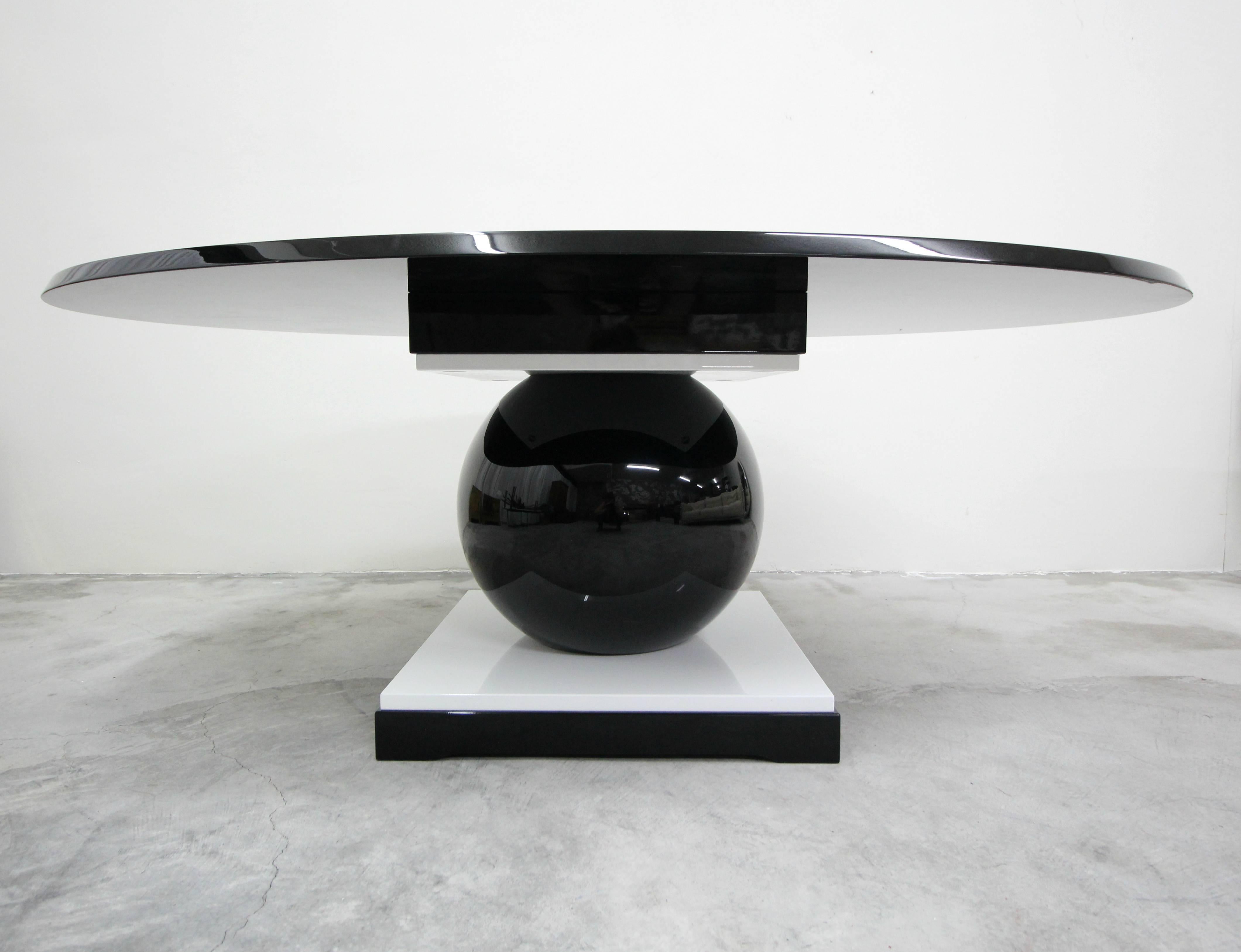 This rare and incredibly chic, black and white lacquered oval dining table was designed in 1918 by Jacques Henri Lartigue.

Lartrigue designed this table for his own use. The gorgeous oval top and base are constructed of black and white lacquered
