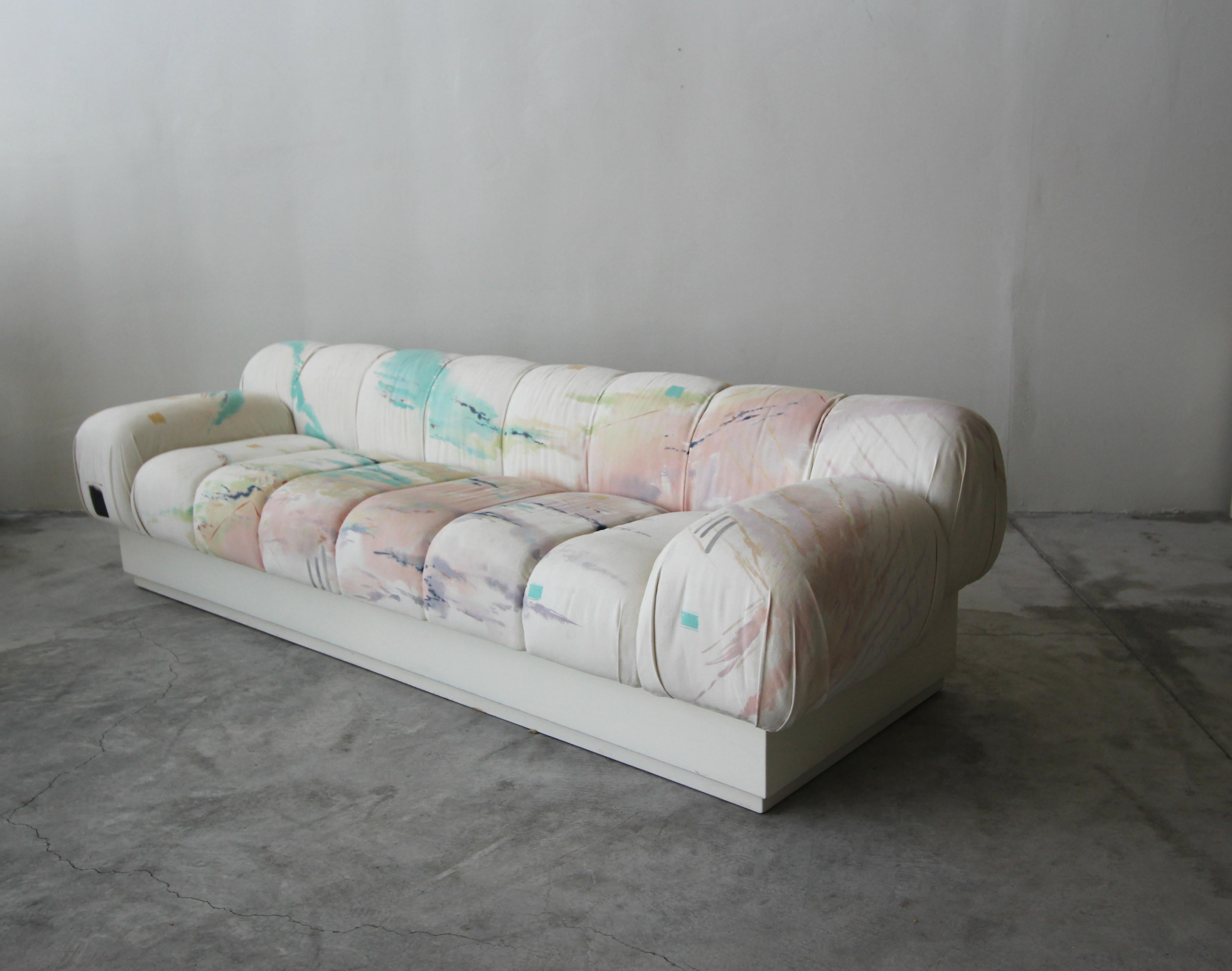 Incredible and large, Postmodern Italian style sofa on a plinth base. Most likely a custom piece, this beauty truly has lines and curves worth coveting. Sofa is large, measuring over 8ft, seats 4-5 people.

Kept as found, in it's Pop Art style,
