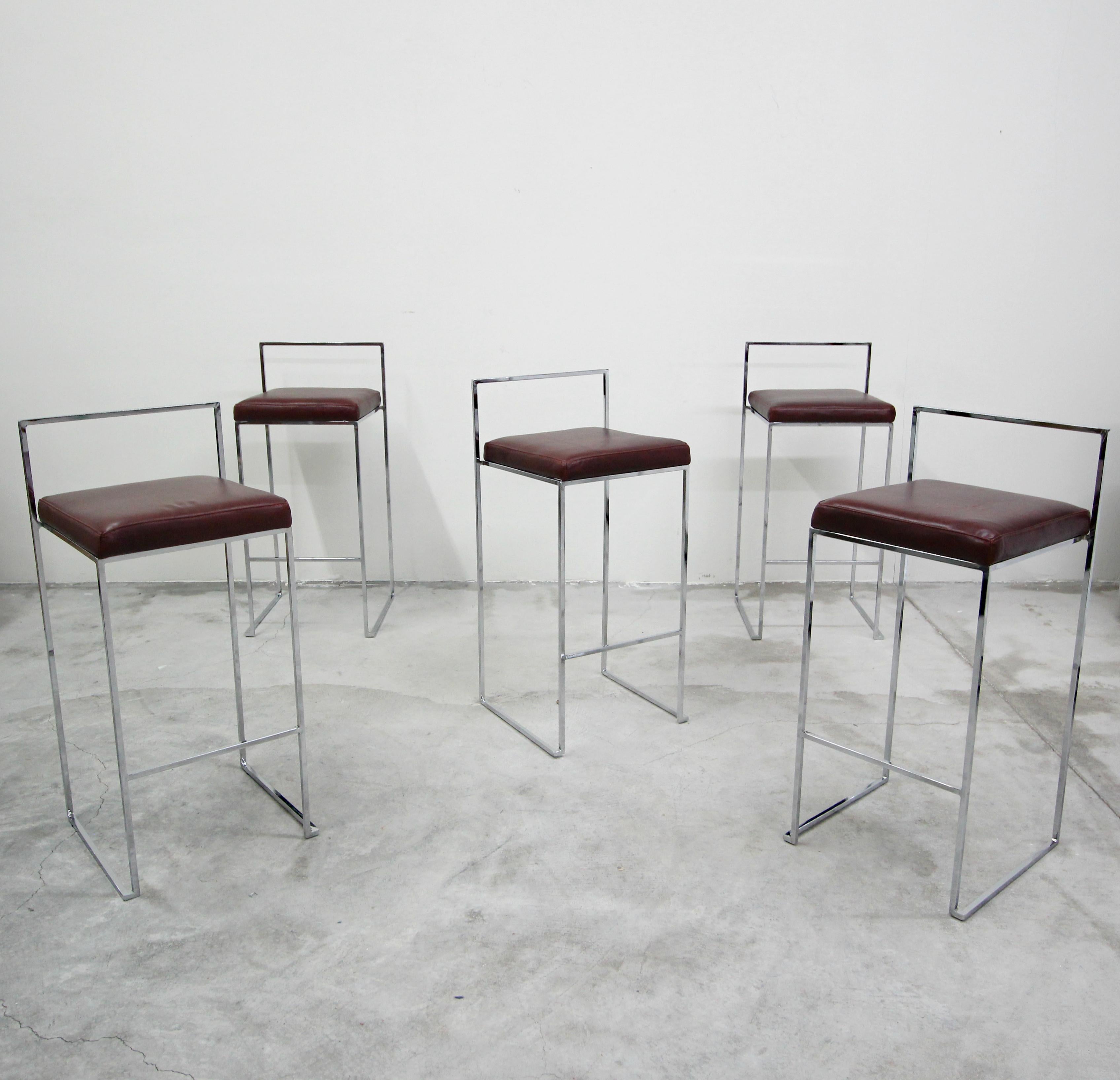 Set of five chrome, bar height stools by Milo Baughman. Stools have simple, thin, clean line chrome frames with all new butter soft maroon leather upholstery. They are in near mint condition and ready for their new home.