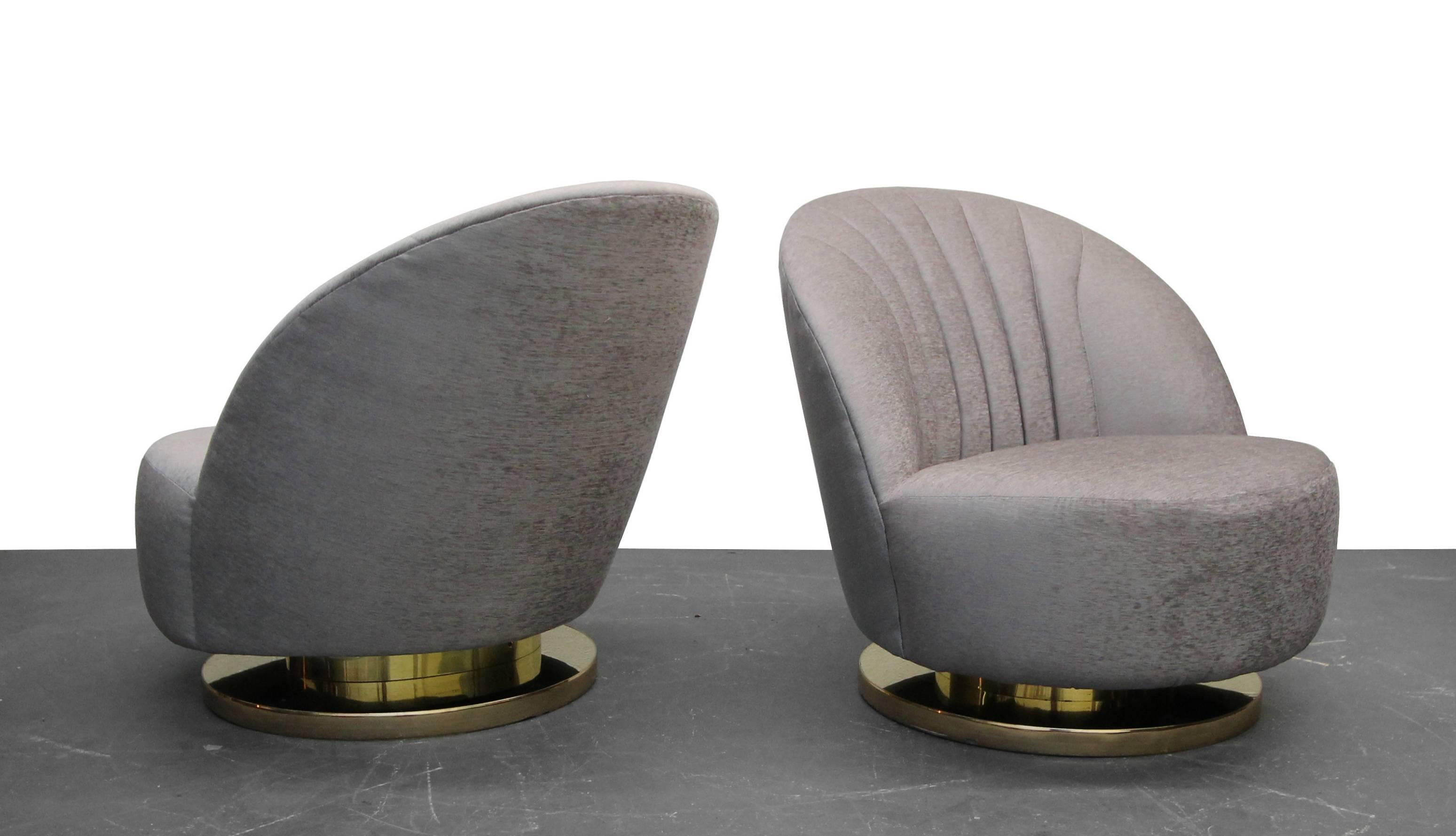 Beautiful pair of midcentury swivel slipper chairs with brass bases by Milo Baughman. A truly gorgeous pair of slipper chairs. Chairs have been professionally reupholstered with all new foam and a beautiful pale lilac purple velvet.