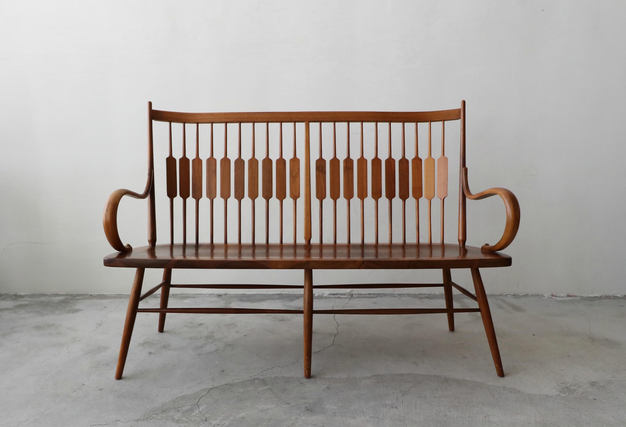 Beautiful midcentury spindle back bench designed by Kipp Stewart and Stewart MacDougall for Drexel Furniture. Bench is constructed of slid walnut. It is in excellent condition with no damage to be noted.
