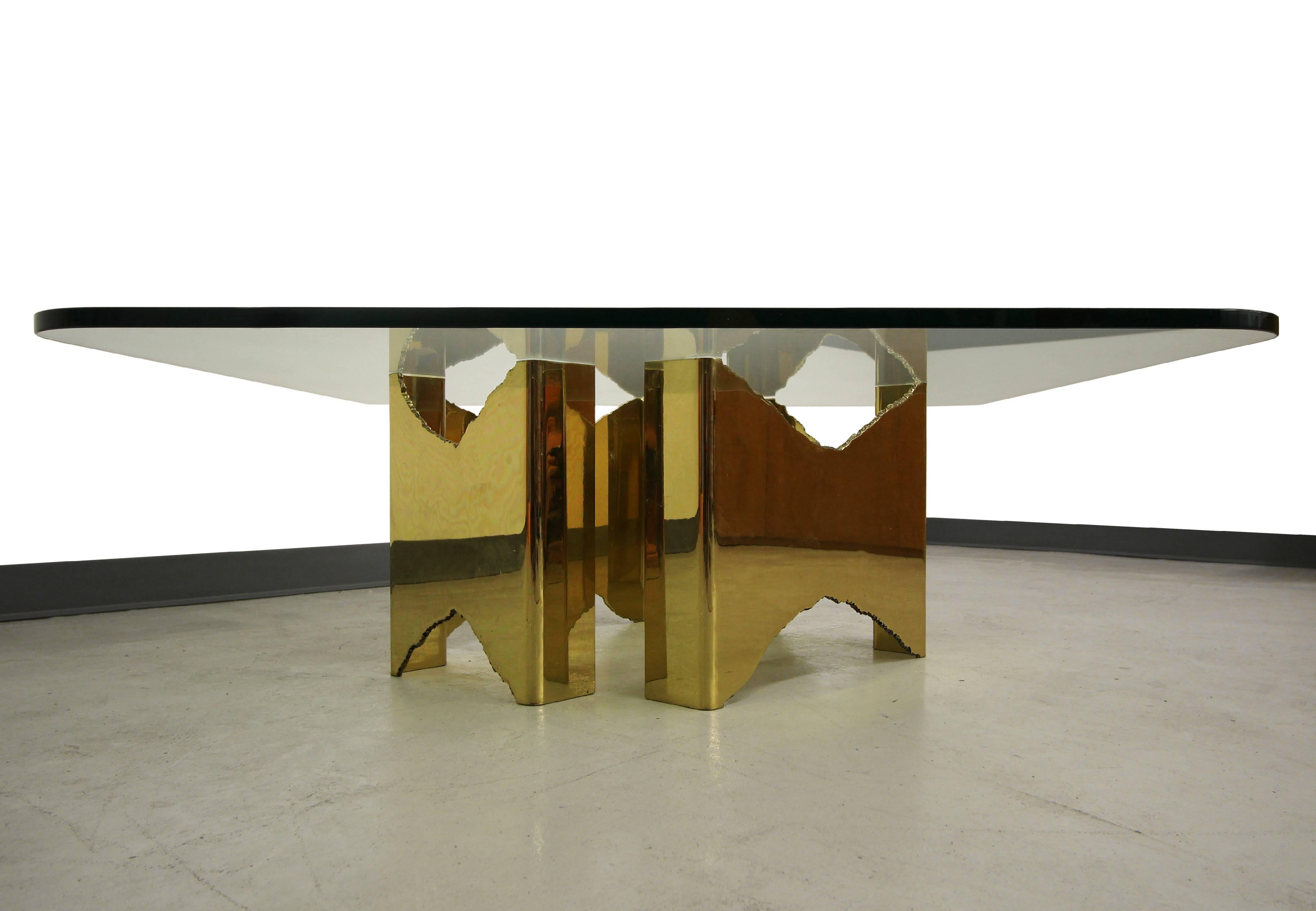 This absolutely stunning SOLID brass coffee table base is a 1 of a kind gem.  The table is comprised of 2 torch cut sections that mirror each other and can be placed in a multitude of positions to create several different table options.  This table