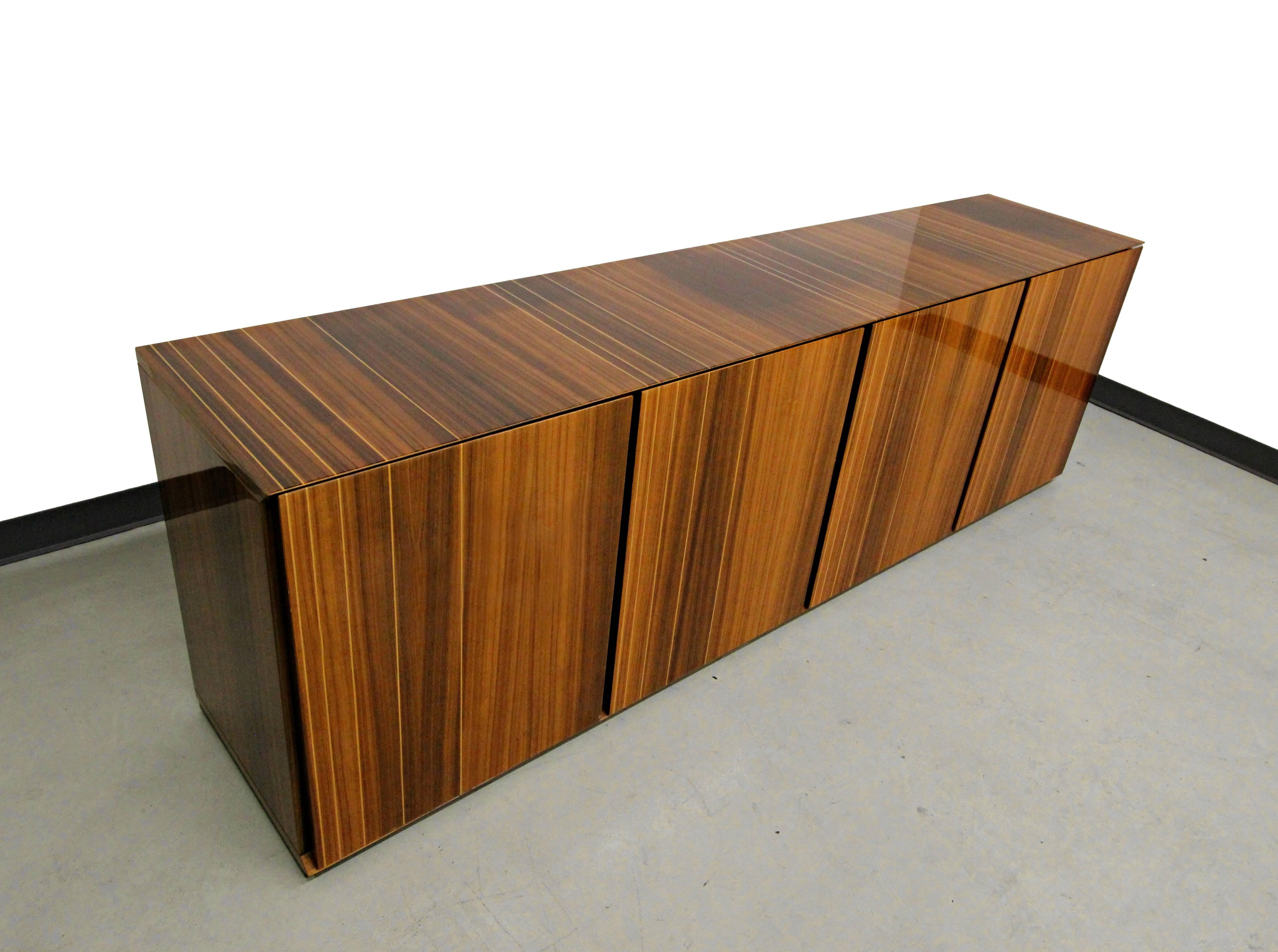 This gorgeous Italian lacquered zebrawood credenza is a monumental beauty measuring in at 7.5ft.  It is a true work of art.  With show stopping grain, gorgeous lacquer sheen and sleek modern lines it's a real statement piece of furniture.